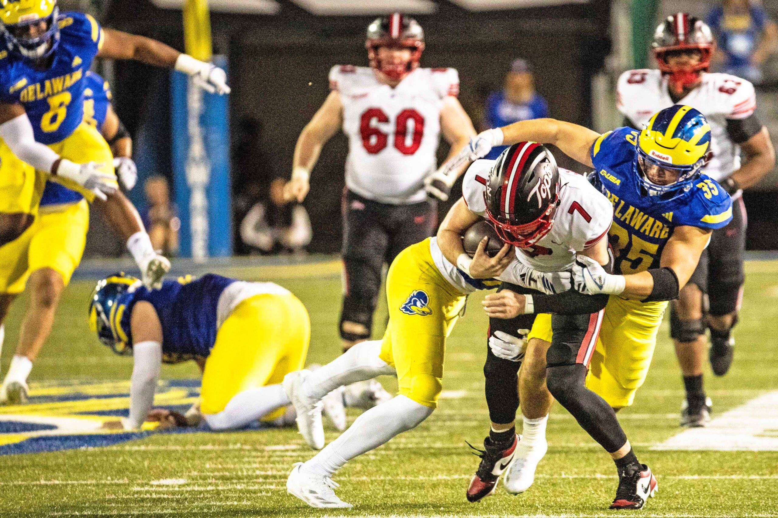 Western Kentucky quarterback Maverick McIvor (7) hangs on to the ball as Delaware Blue Hens safety KT Seay (7) and linebacker Gavin Moul (35) wrap him up for the takedown during Delaware's first home CUSA football game, which was nationally televised, at Delaware Stadium in Newark on Oct. 3, 2025. Western Kentucky won 27-24.