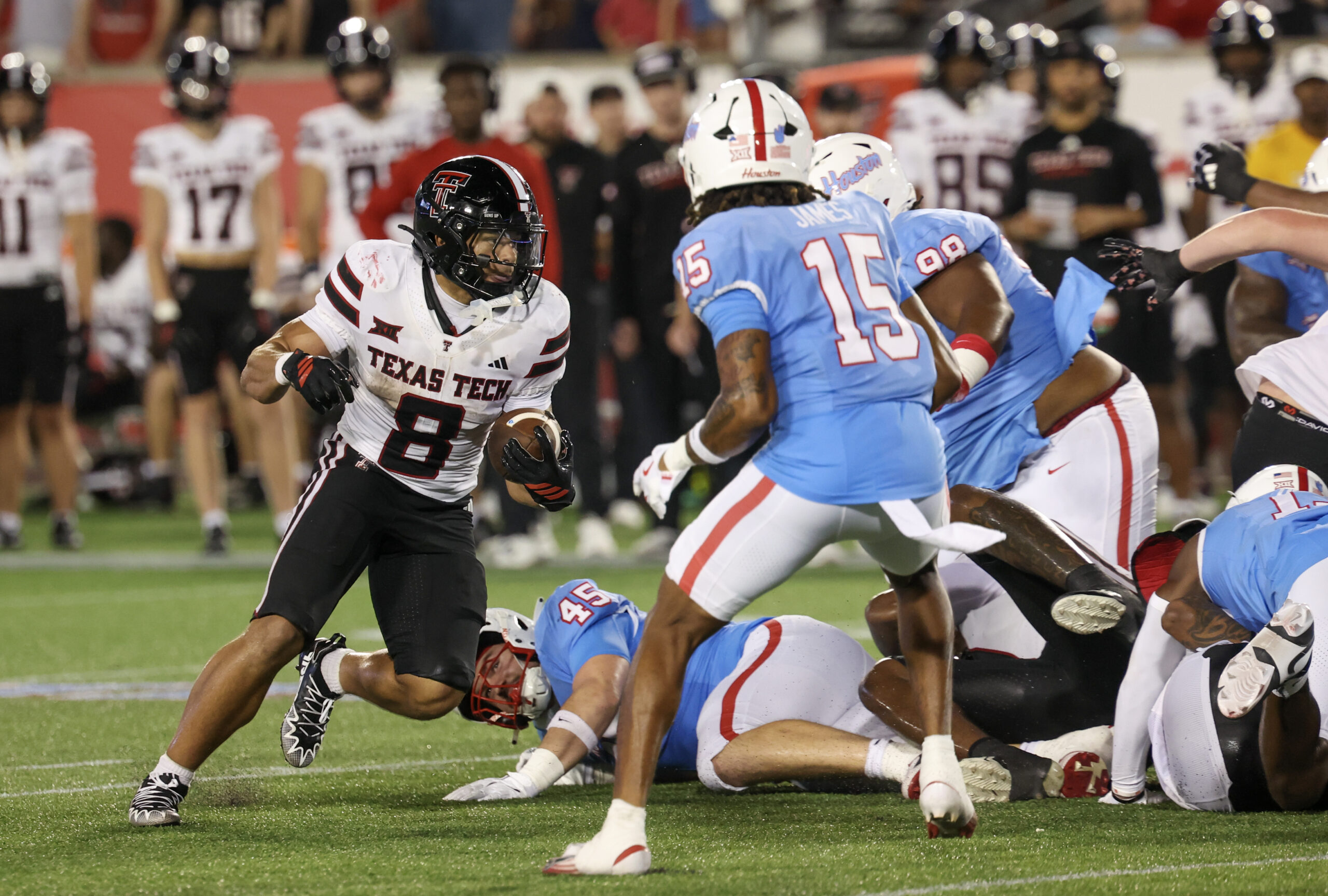 Oct 4, 2025; Houston, Texas, USA; Texas Tech Red Raiders running back Cameron Dickey (8) rushes against Houston Cougars defensive back Will James (15) in the second half at TDECU Stadium. Mandatory Credit: Thomas Shea-Imagn Images