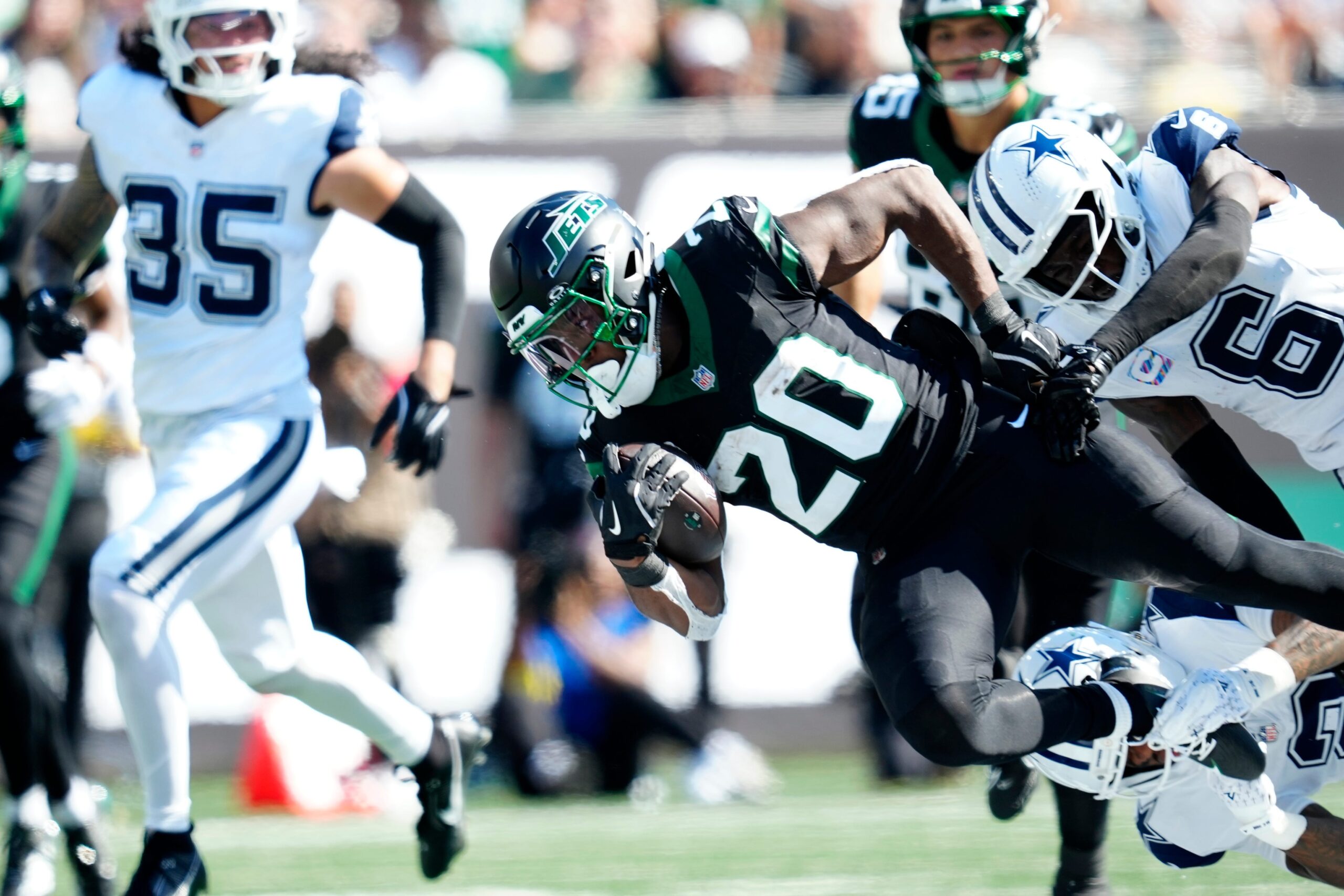 New York Jets running back Breece Hall (20), is tackled by the Dallas defense, Sunday, October 5, 2025.
