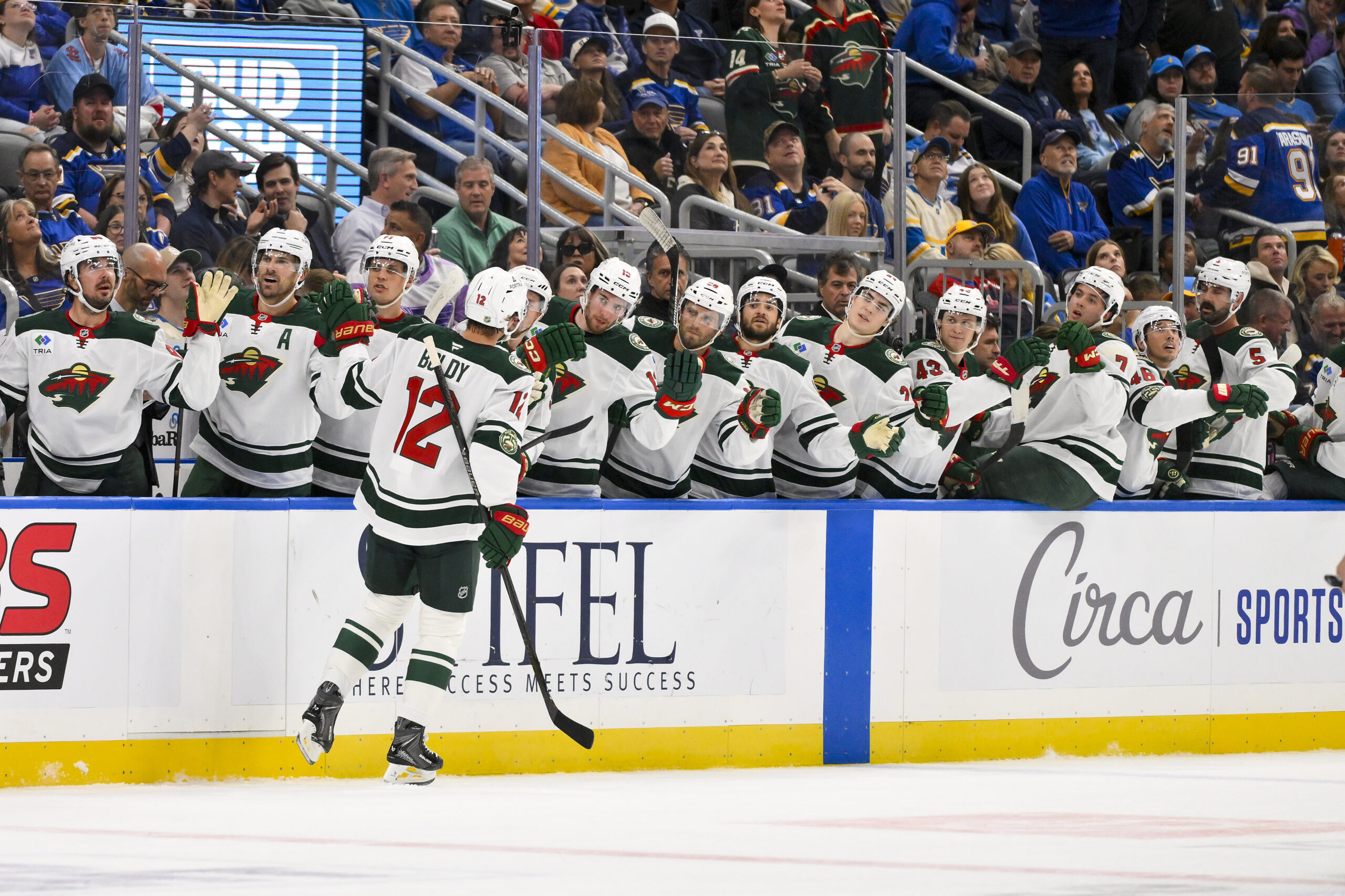 Oct 9, 2025; St. Louis, Missouri, USA; Minnesota Wild left wing Matt Boldy (12) is congratulated by teammates after scoring against the St. Louis Blues during the first period at Enterprise Center. Mandatory Credit: Jeff Curry-Imagn Images