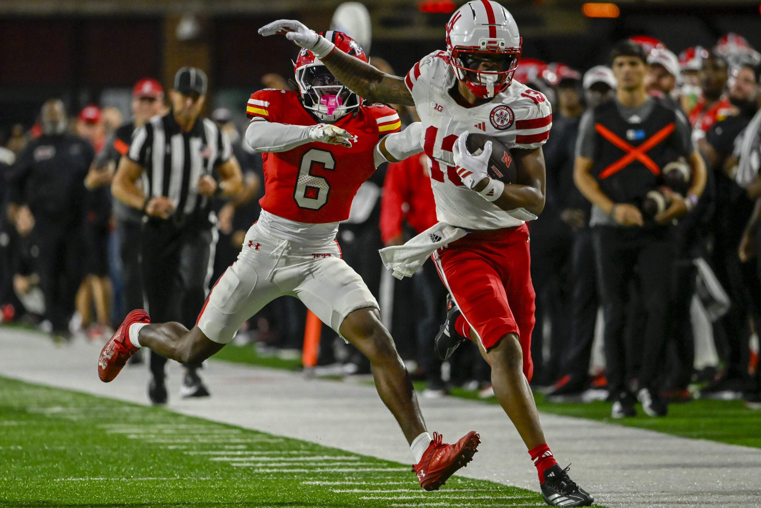 Oct 11, 2025; College Park, Maryland, USA;  Nebraska Cornhuskers wide receiver Nyziah Hunter (13) runs for a first down as Maryland Terrapins defensive back Dontay Joyner (6) defends during the second half at SECU Stadium. Mandatory Credit: Tommy Gilligan-Imagn Images