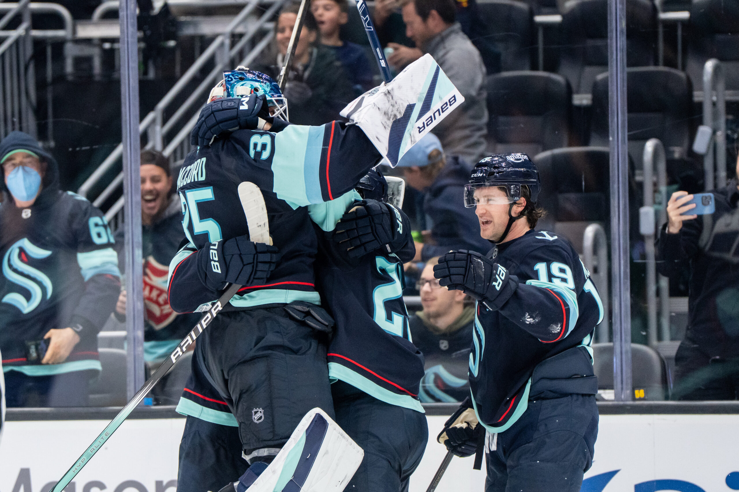 Oct 11, 2025; Seattle, Washington, USA; Seattle Kraken forward Jared McCann (19) celebrates with defenseman Joey Daccord (35) and defenseman Vince Dunn (29) after scoring a goal in overtime against against the Vegas Golden Knights at Climate Pledge Arena. Mandatory Credit: Stephen Brashear-Imagn Images