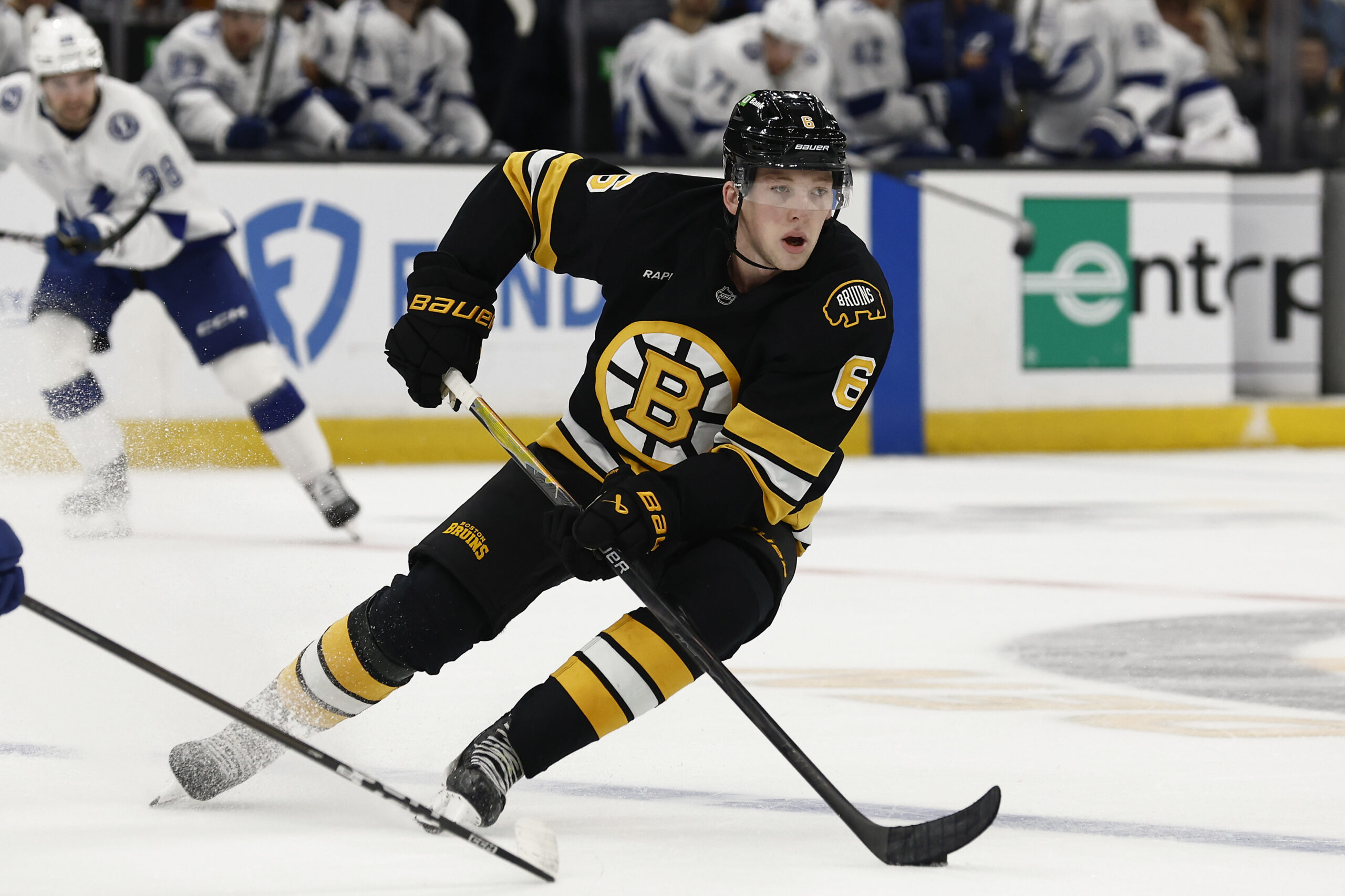 Oct 13, 2025; Boston, Massachusetts, USA; Boston Bruins defenseman Mason Lohrei (6) carries the puck during the second period against the Tampa Bay Lightning at TD Garden. Mandatory Credit: Winslow Townson-Imagn Images