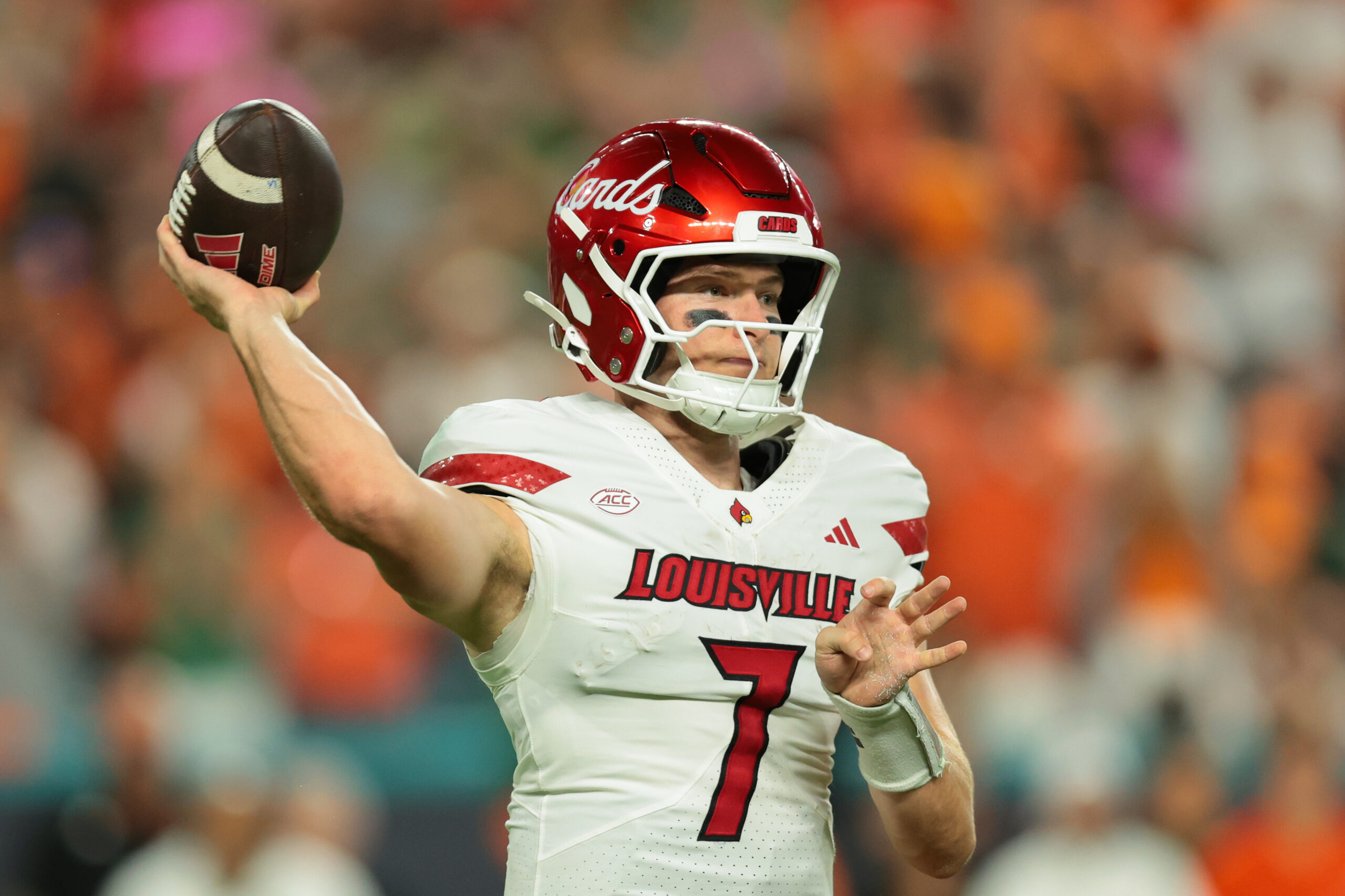 Oct 17, 2025; Miami Gardens, Florida, USA; Louisville Cardinals quarterback Miller Moss (7) throws the football against the Miami Hurricanes during the second quarter at Hard Rock Stadium. Mandatory Credit: Sam Navarro-Imagn Images