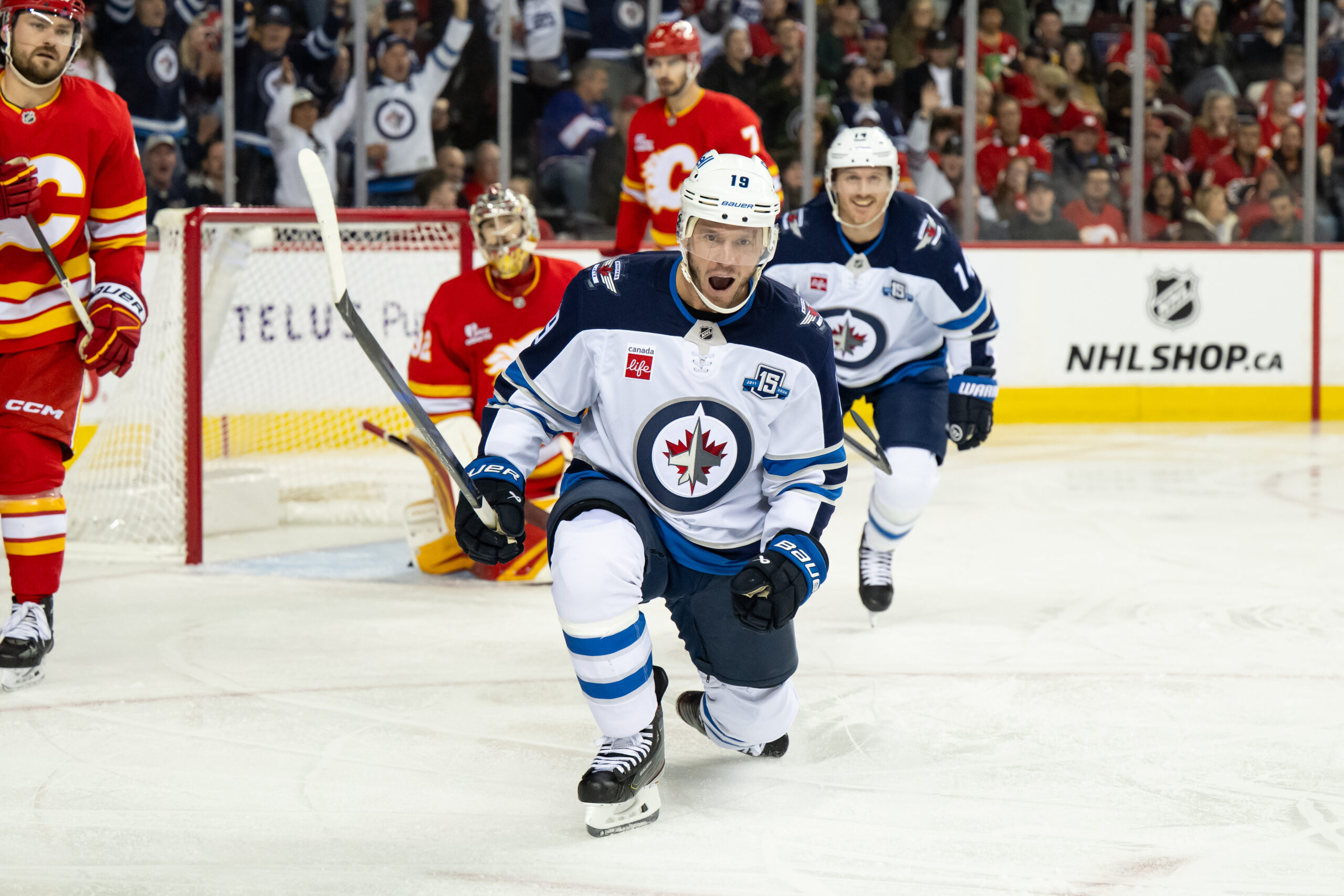 Oct 20, 2025; Calgary, Alberta, CAN; Winnipeg Jets center Jonathan Toews (19) celebrates after scoring a goal on Calgary Flames goaltender Dustin Wolf (32) during the third period at Scotiabank Saddledome. Mandatory Credit: Brett Holmes-Imagn Images