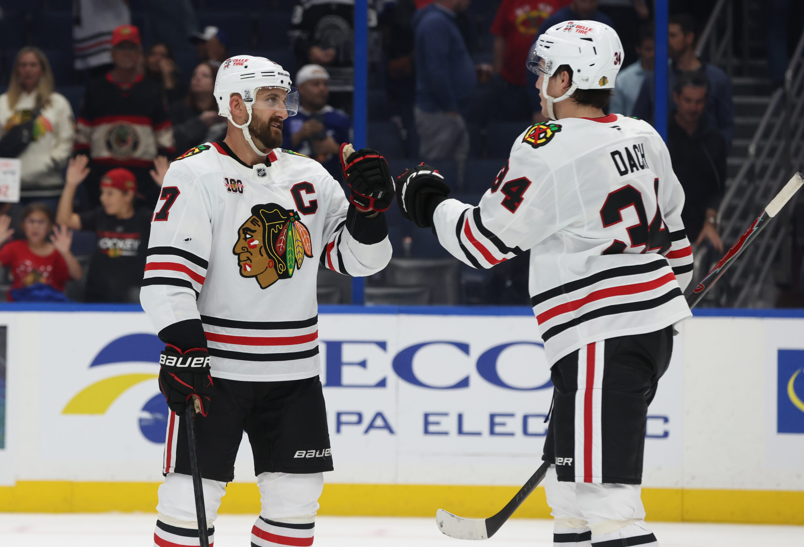 Oct 23, 2025; Tampa, Florida, USA; Chicago Blackhawks left wing Nick Foligno (17) and center Colton Dach (34) celebrate after they beat the Tampa Bay Lightning at Benchmark International Arena. Mandatory Credit: Kim Klement Neitzel-Imagn Images