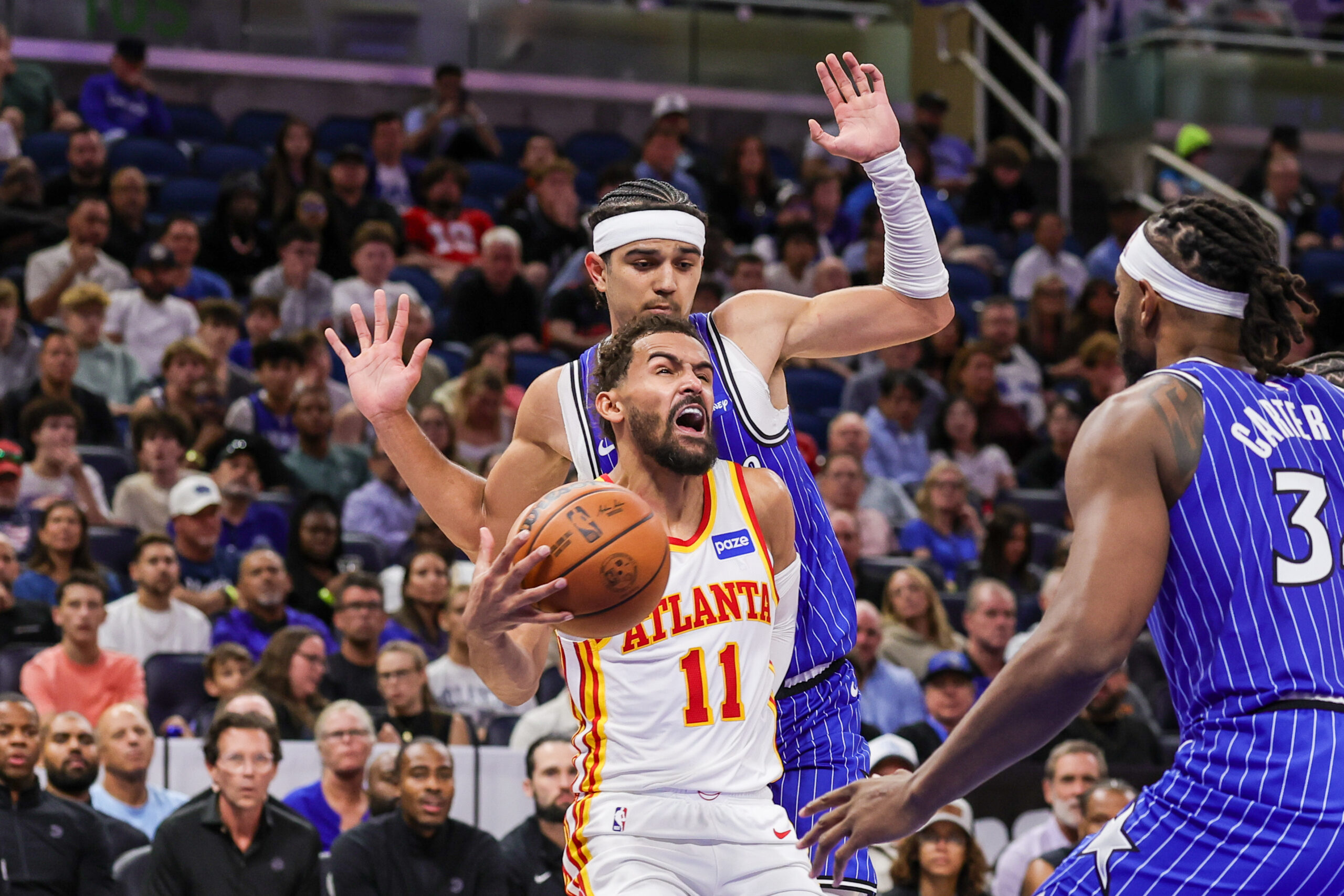 Oct 24, 2025; Orlando, Florida, USA; Atlanta Hawks guard Trae Young (11) is fouled by Orlando Magic guard Anthony Black (0) during the second quarter at Kia Center. Mandatory Credit: Mike Watters-Imagn Images
