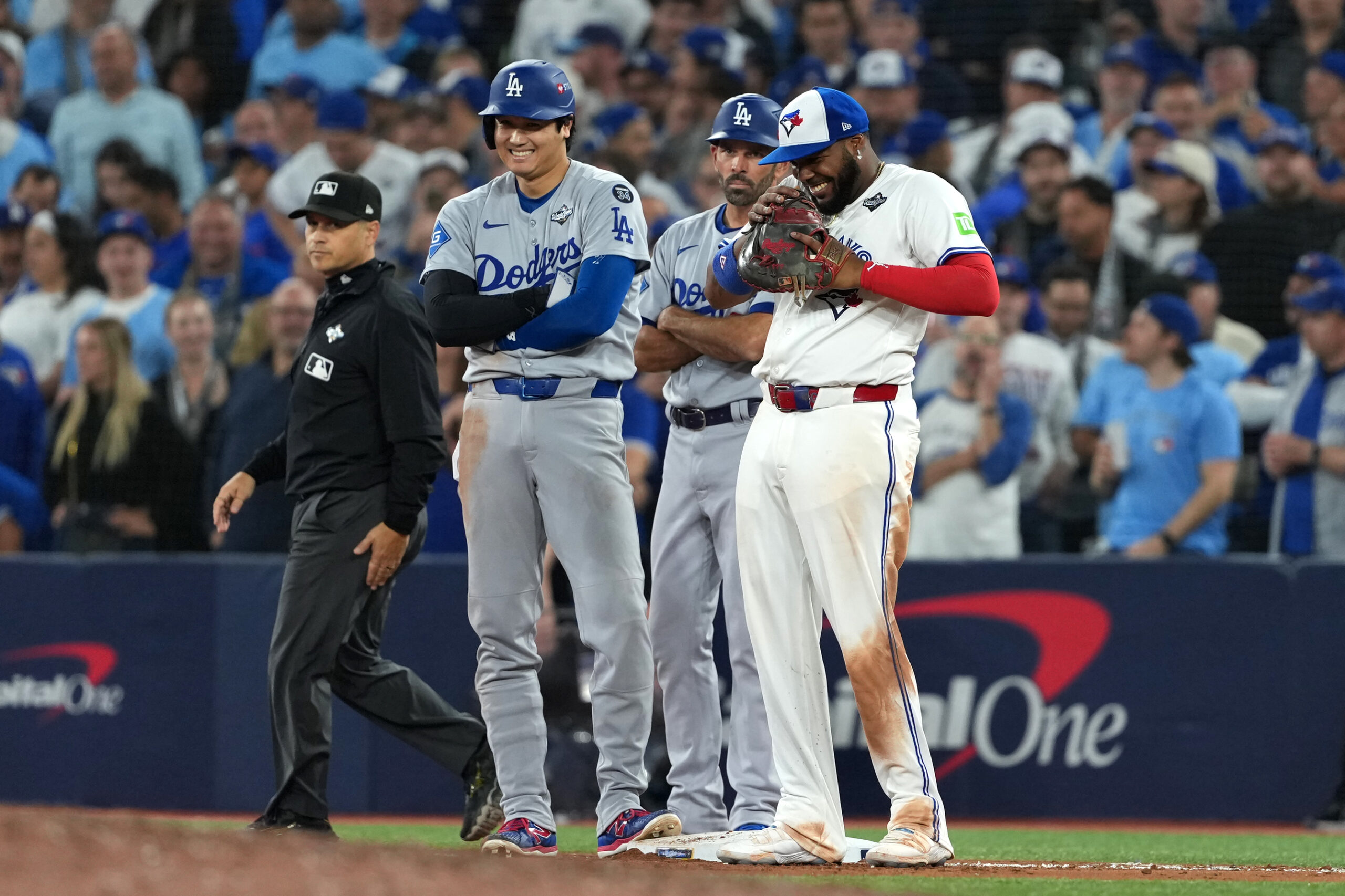 Oct 24, 2025; Toronto, Ontario, CAN; Los Angeles Dodgers two-way player Shohei Ohtani (17) and Toronto Blue Jays first baseman Vladimir Guerrero Jr. (27) react in the ninth inning during game one of the 2025 MLB World Series at Rogers Centre. Mandatory Credit: Nick Turchiaro-Imagn Images