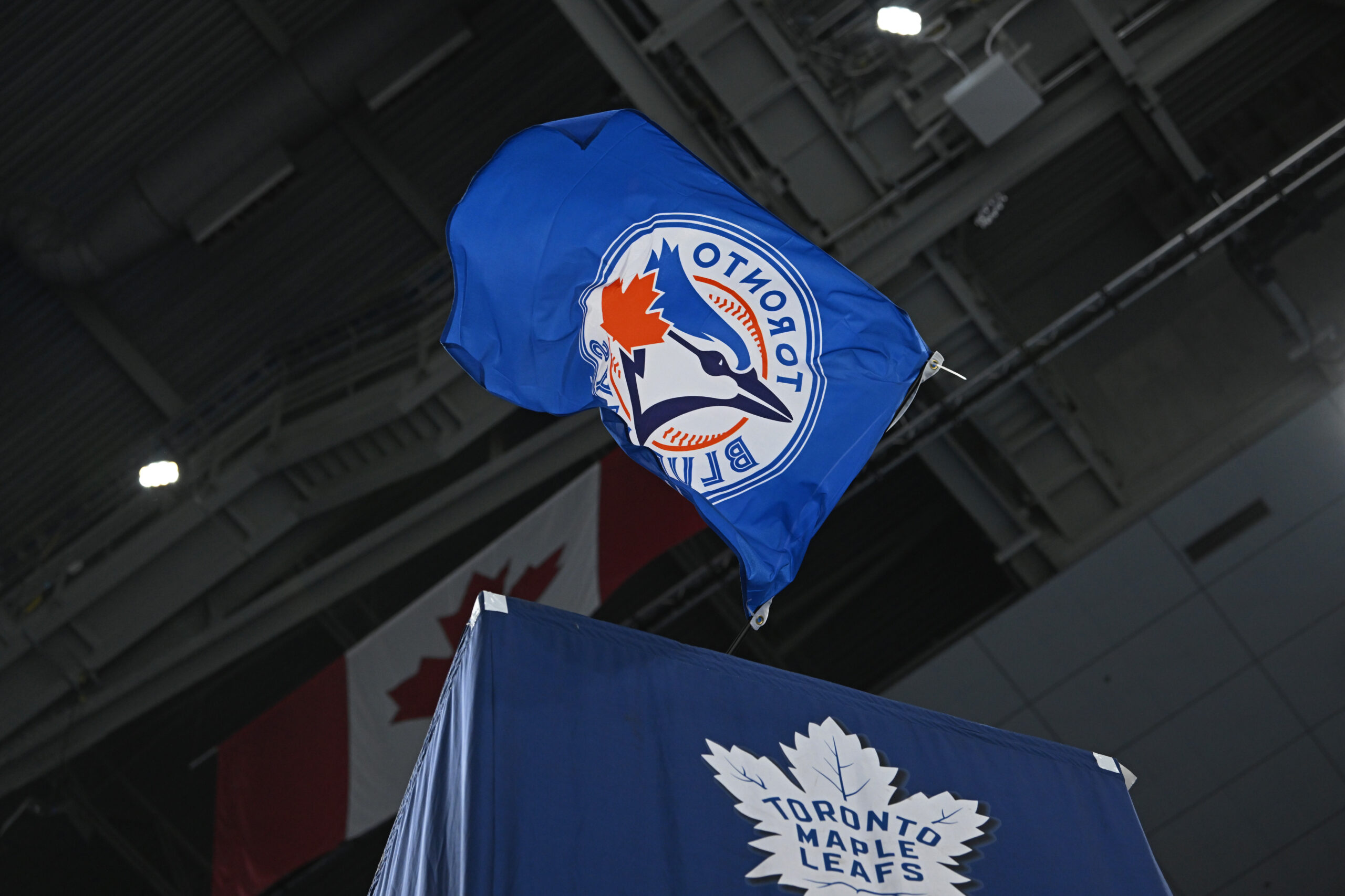 Oct 25, 2025; Toronto, Ontario, CAN; The Toronto Blue Jays flag is waved by the Toronto Maple Leafs against the Buffalo Sabres at Scotiabank Arena. Mandatory Credit: Gerry Angus-Imagn Images