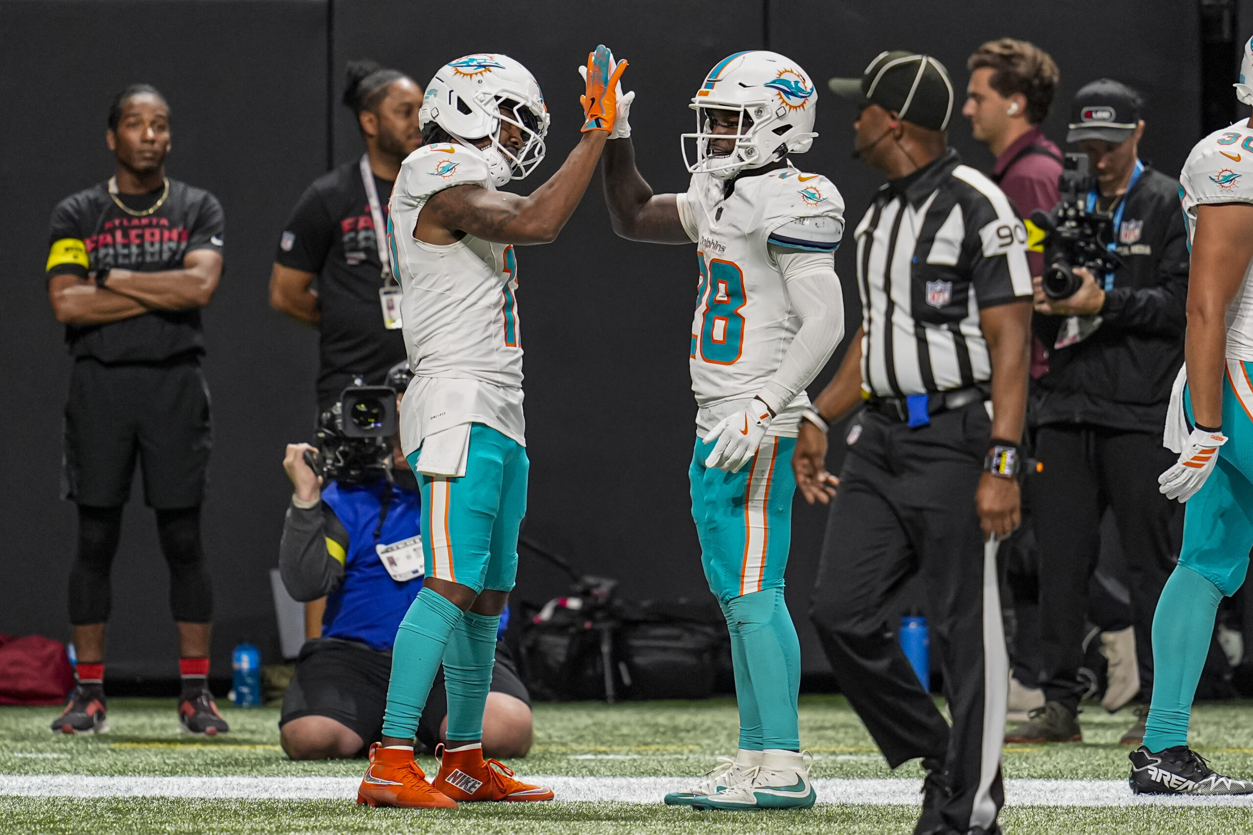 Oct 26, 2025; Atlanta, Georgia, USA; Miami Dolphins wide receiver Jaylen Waddle (17) reacts with running back De'Von Achane (28)  after running for a touchdown past Atlanta Falcons safety Jessie Bates III (3) during the second half at Mercedes-Benz Stadium. Mandatory Credit: Dale Zanine-Imagn Images