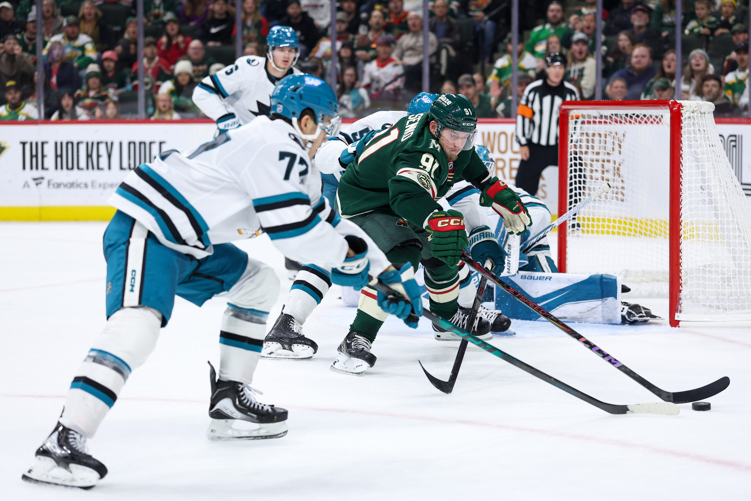 Oct 26, 2025; Saint Paul, Minnesota, USA; Minnesota Wild right wing Vladimir Tarasenko (91) and San Jose Sharks left wing William Eklund (72) compete for the puck during the third period at Grand Casino Arena. Mandatory Credit: Matt Krohn-Imagn Images