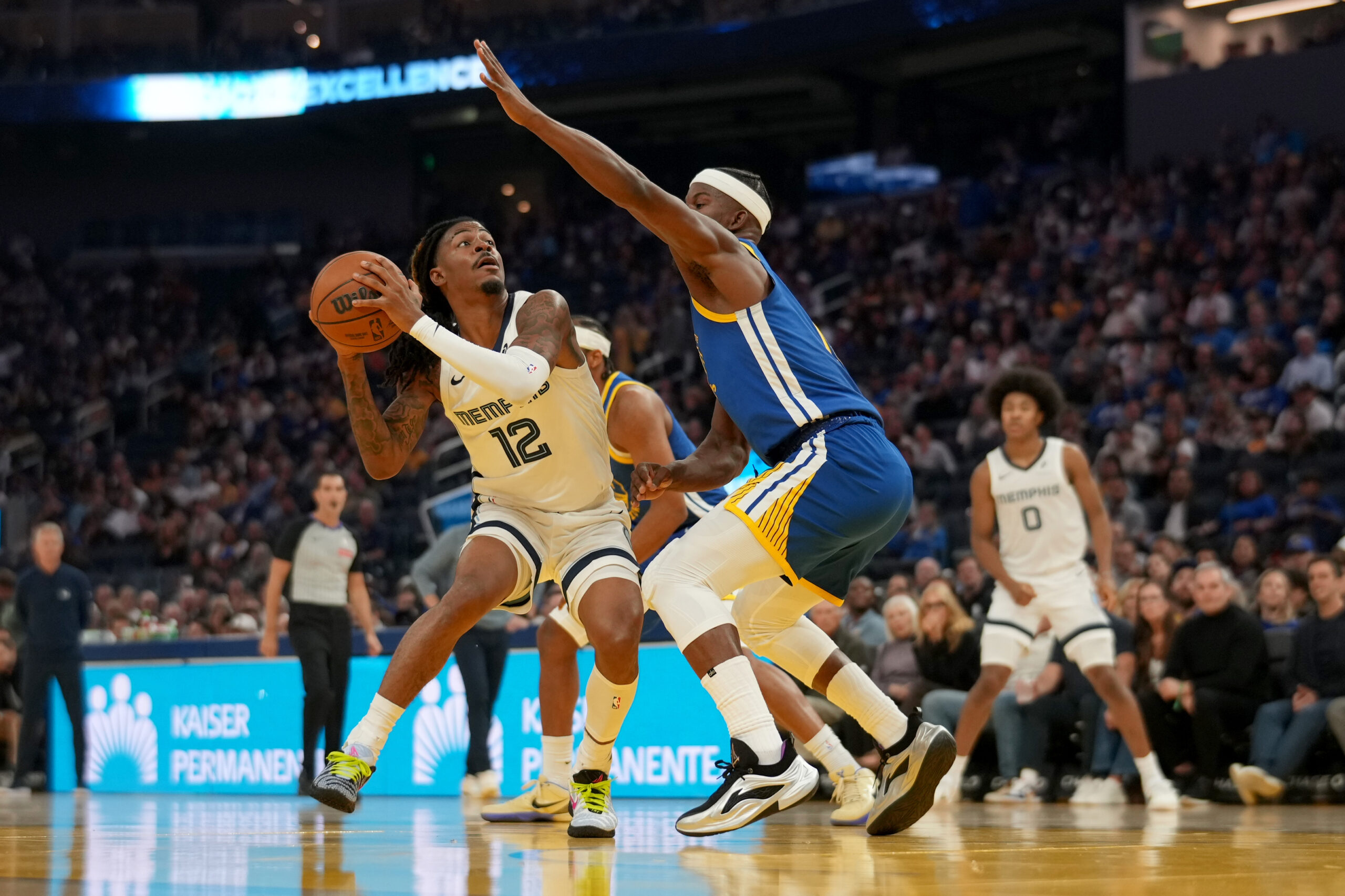 Oct 27, 2025; San Francisco, California, USA; Memphis Grizzlies guard Ja Morant (12) holds onto the ball next to Golden State Warriors forward Jimmy Butler III (10) in the second quarter at the Chase Center. Mandatory Credit: Cary Edmondson-Imagn Images