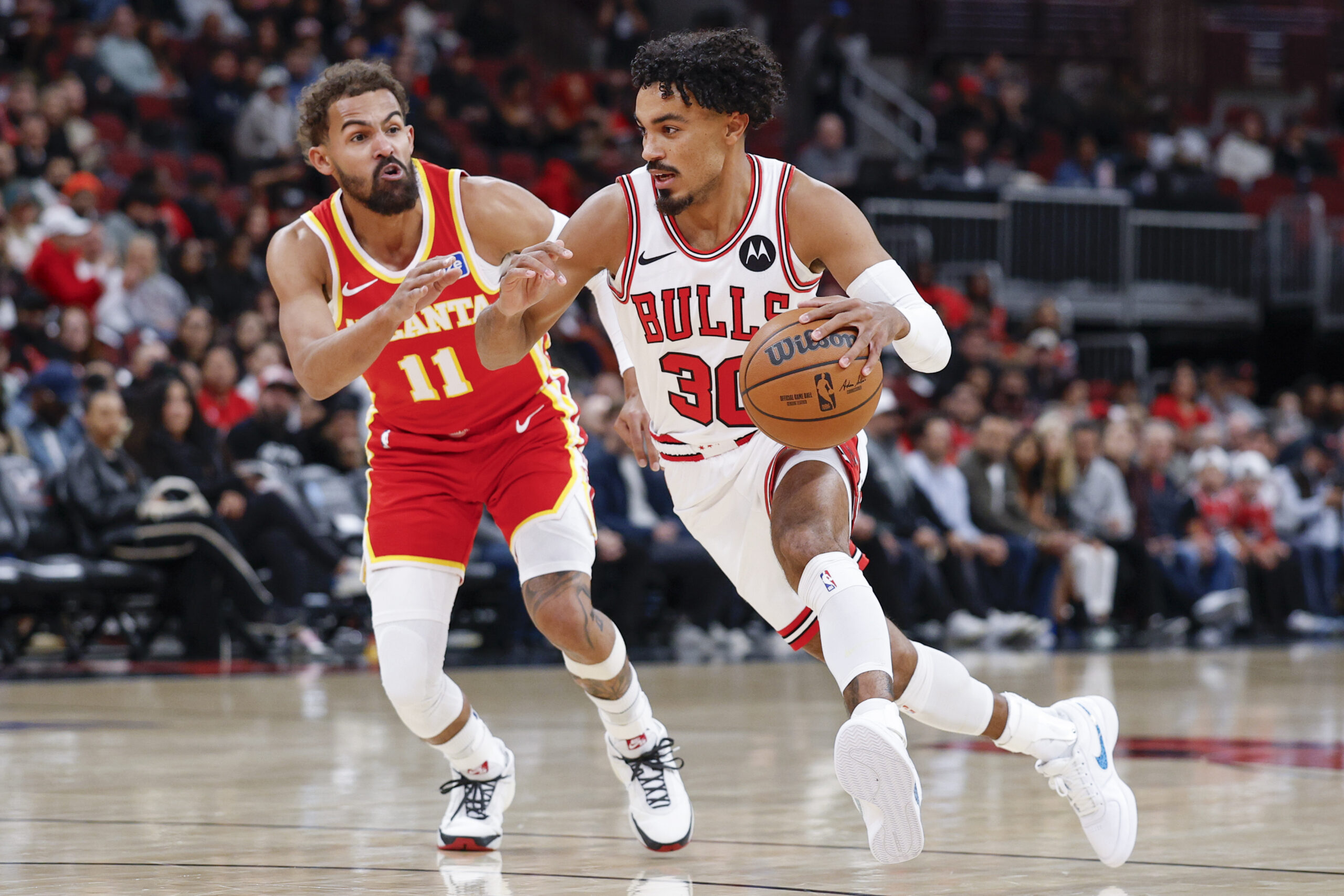 Oct 27, 2025; Chicago, Illinois, USA; Chicago Bulls guard Tre Jones (30) drives to the basket against Atlanta Hawks guard Trae Young (11) during the first half at United Center. Mandatory Credit: Kamil Krzaczynski-Imagn Images