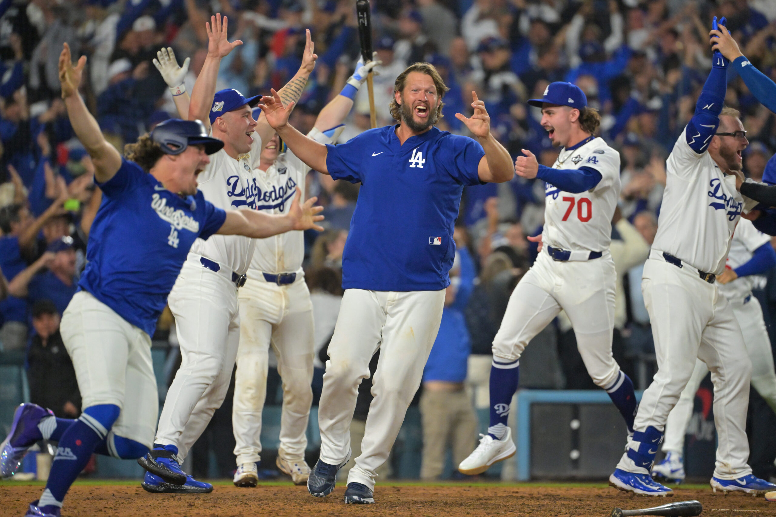 Oct 27, 2025; Los Angeles, California, USA; Los Angeles Dodgers pitcher Clayton Kershaw (22) celebrates with teammates after first baseman Freddie Freeman (5) hit a walk off home run against the Toronto Blue Jays in the eighteenth inning during game three of the 2025 MLB World Series at Dodger Stadium. Mandatory Credit: Jayne Kamin-Oncea-Imagn Images