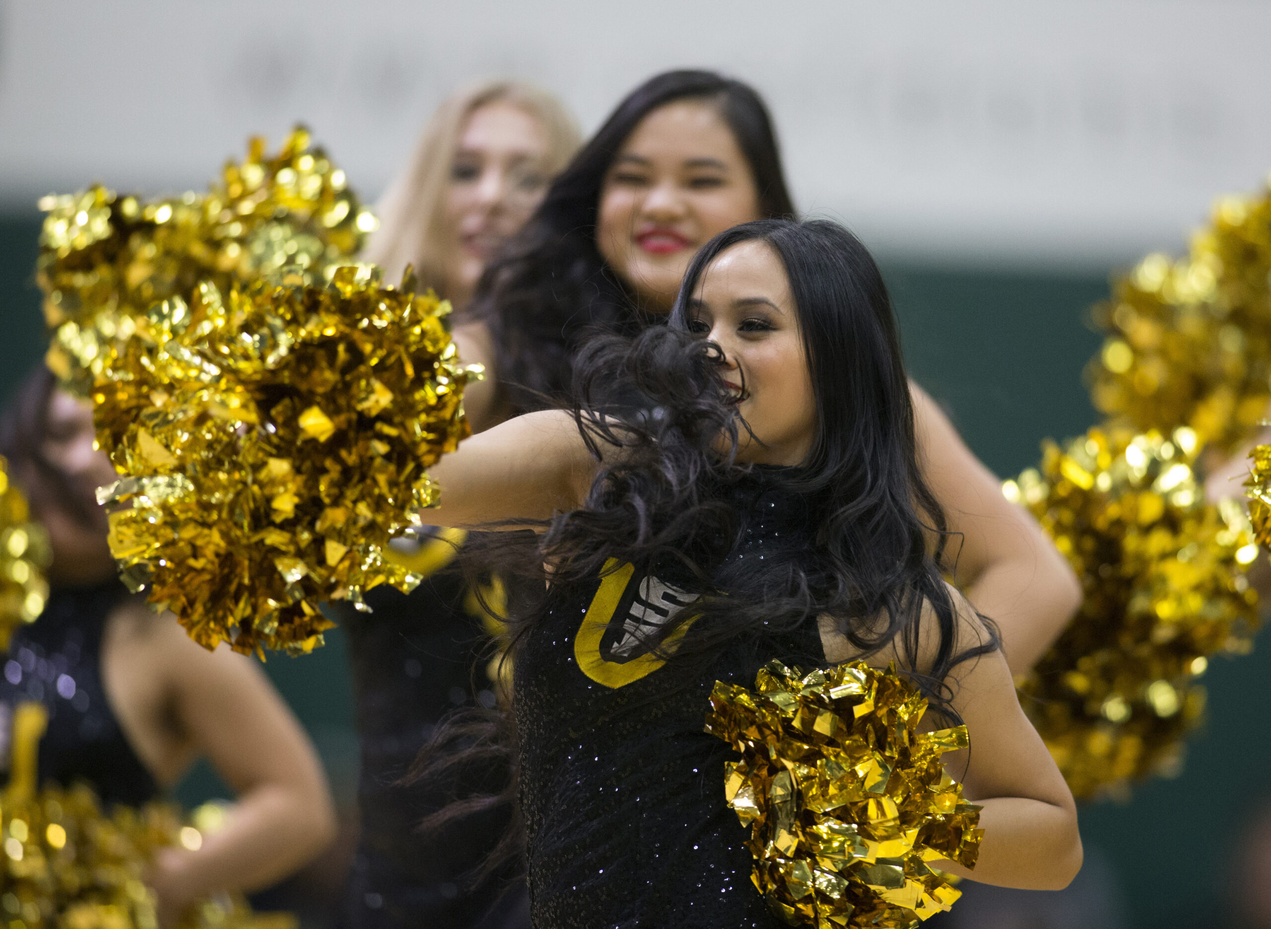 Feb 15, 2018; San Francisco, CA, USA; Cheerleaders entertain the crowd during a timeout in the first half of an NCAA men's college basketball game between the San Francisco Dons and the Saint Mary s Gaels at War Memorial Gymnasium. Mandatory Credit: D. Ross Cameron-Imagn Images