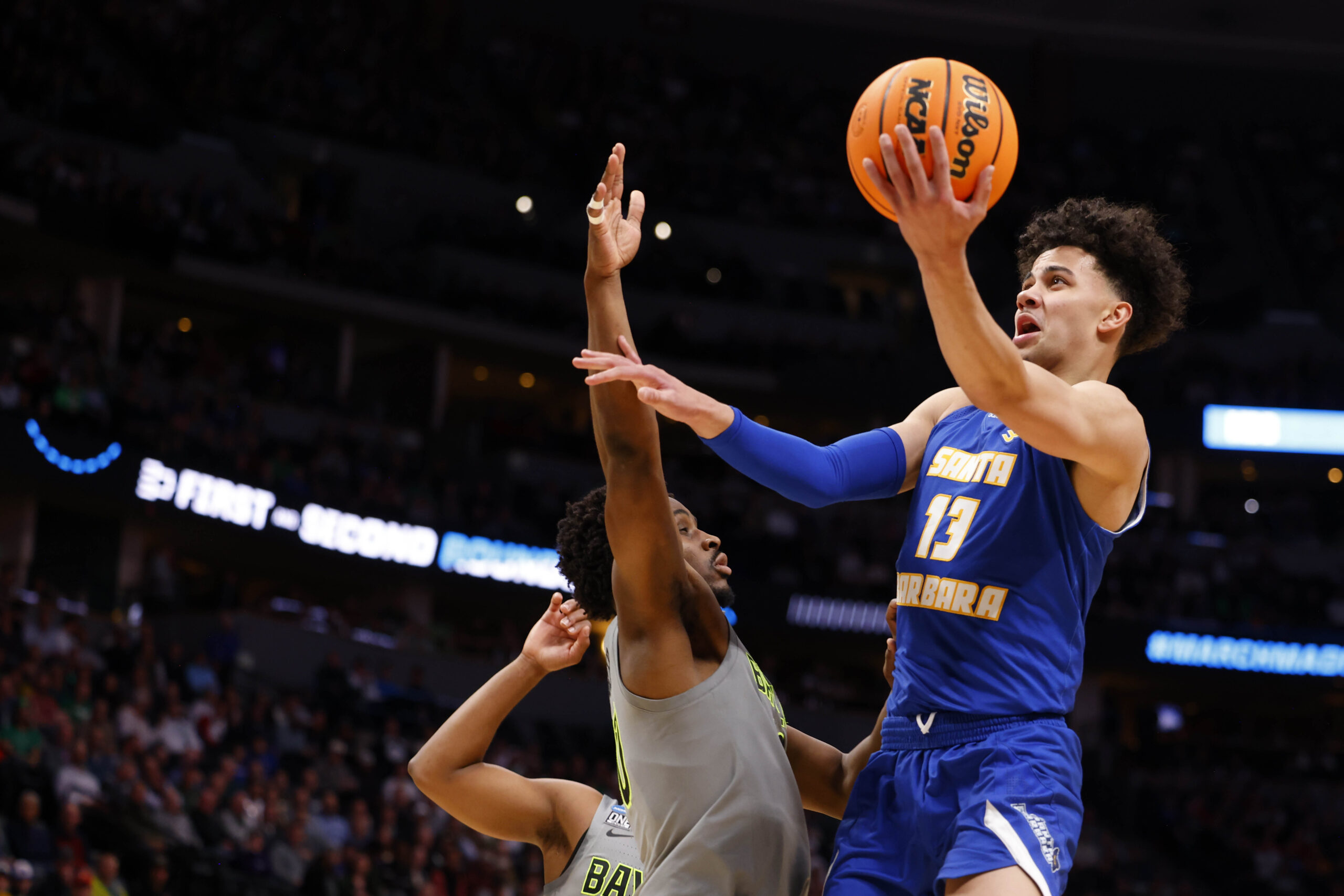 Mar 17, 2023; Denver, CO, USA;  UC Santa Barbara Gauchos guard Ajay Mitchell (13) drives to the basket against Baylor Bears during the first half in the first round of the 2023 NCAA men   s basketball tournament at Ball Arena. Mandatory Credit: Michael Ciaglo-Imagn Images