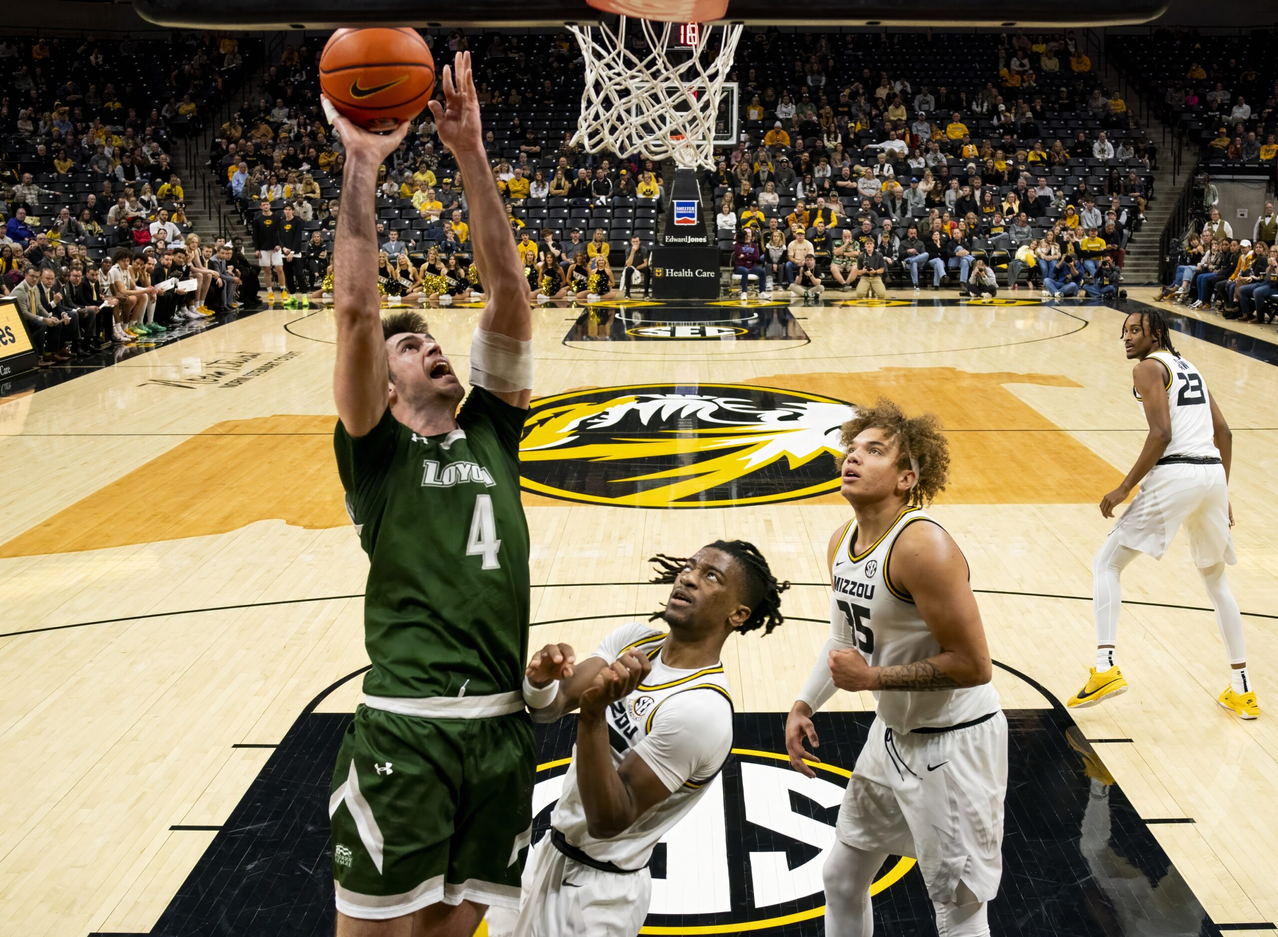 Nov 25, 2023; Columbia, Missouri, USA; Loyola (Md) Greyhounds forward Alonso Faure (4) shoots against Missouri Tigers guard Sean East II (55) and forward Noah Carter (35) during the second half at Mizzou Arena. Mandatory Credit: Jay Biggerstaff-Imagn Images