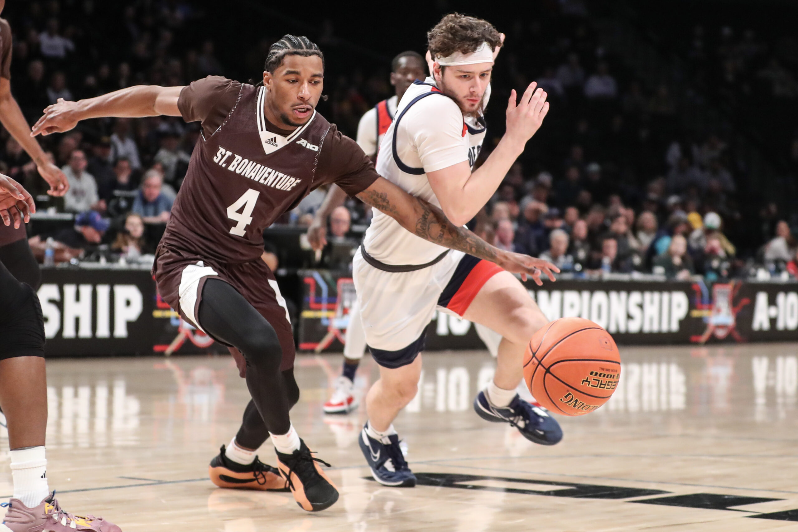 Mar 16, 2024; Brooklyn, NY, USA;  St. Bonaventure Bonnies guard Moses Flowers (4) and Duquesne Dukes guard Jake DiMichele (44) fight for a loose ball in the first half at Barclays Center. Mandatory Credit: Wendell Cruz-Imagn Images