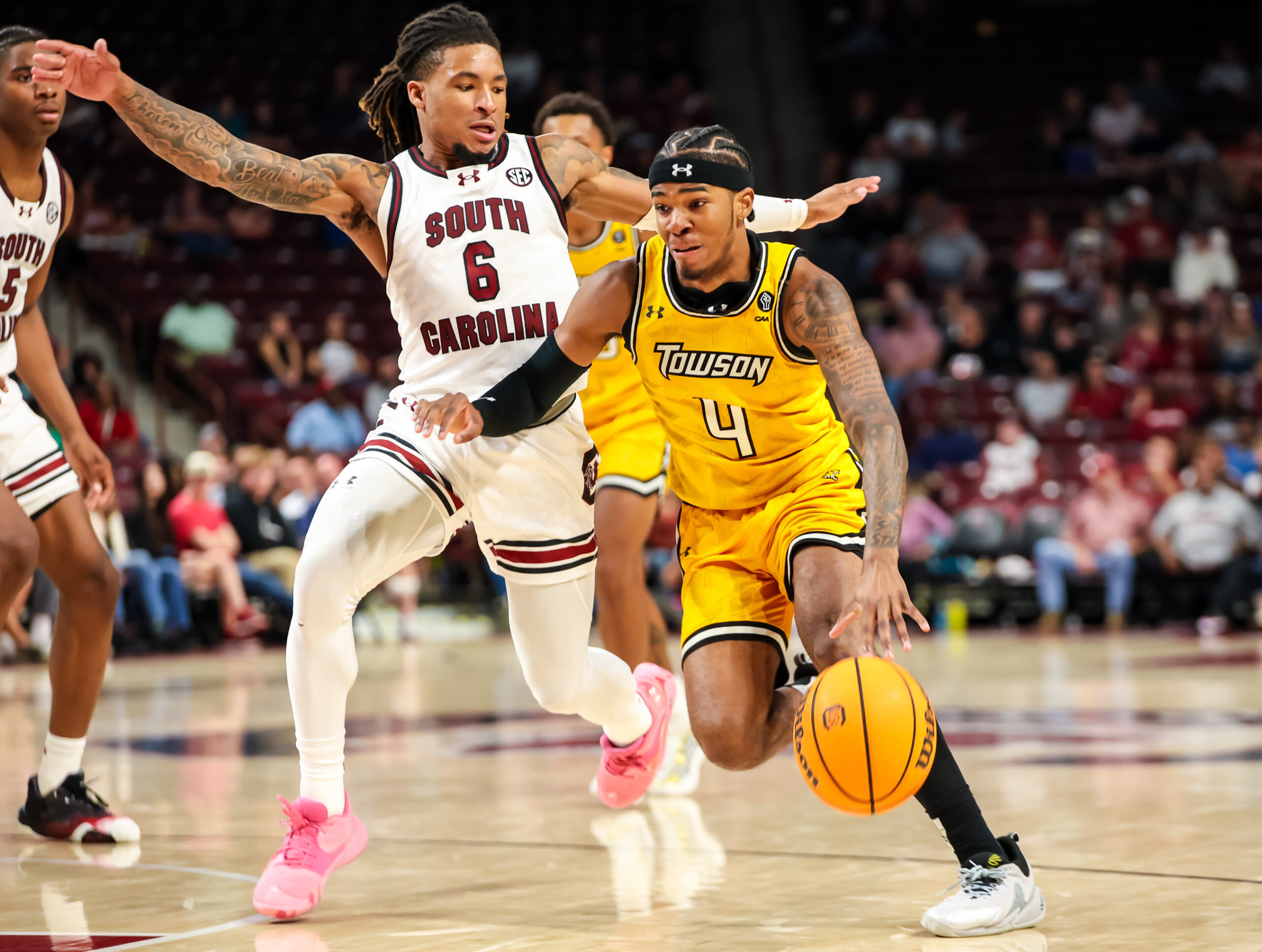 Nov 12, 2024; Columbia, South Carolina, USA; Towson Tigers guard Dylan Williamson (4) drives past South Carolina Gamecocks guard Jamarii Thomas (6) in the second half at Colonial Life Arena. Mandatory Credit: Jeff Blake-Imagn Images