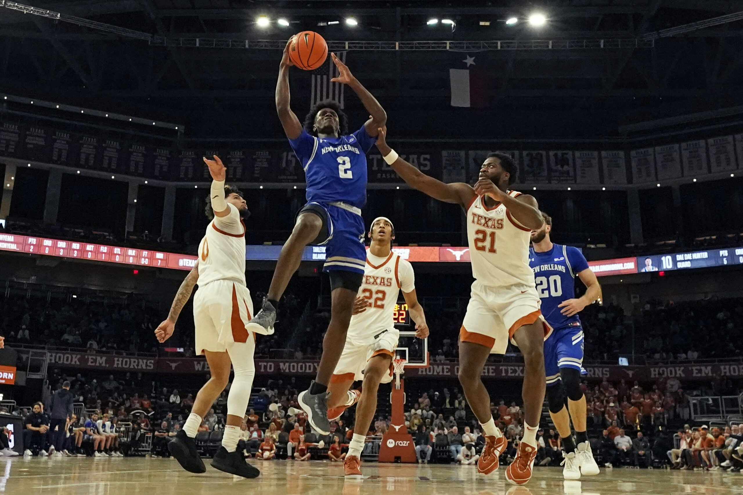 Dec 19, 2024; Austin, Texas, USA; New Orleans Privateers guard Jah Short (2) drives to the basket past Texas Longhorns guard Jordan Pope (0) and forward Ze'Rik Onyema (21) during the first half at Moody Center. Mandatory Credit: Scott Wachter-Imagn Images