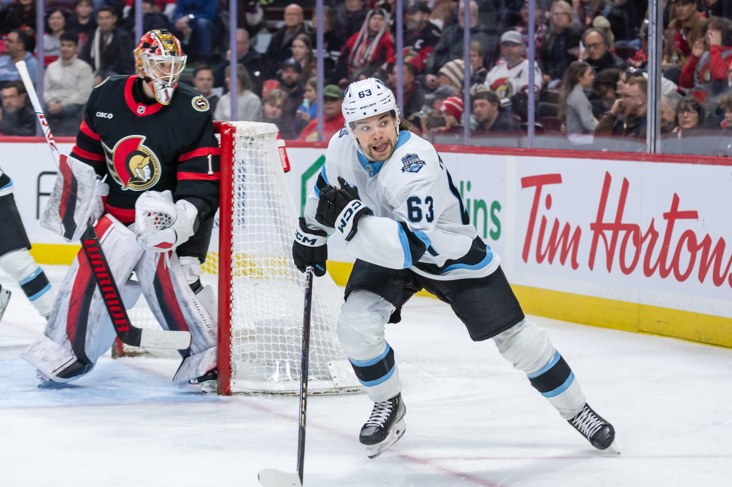 Jan 26, 2025; Ottawa, Ontario, CAN; Utah left wing Matias Maccelli (63) chases the puck in the second period against the Ottawa Senators at the Canadian Tire Centre. Mandatory Credit: Marc DesRosiers-Imagn Images