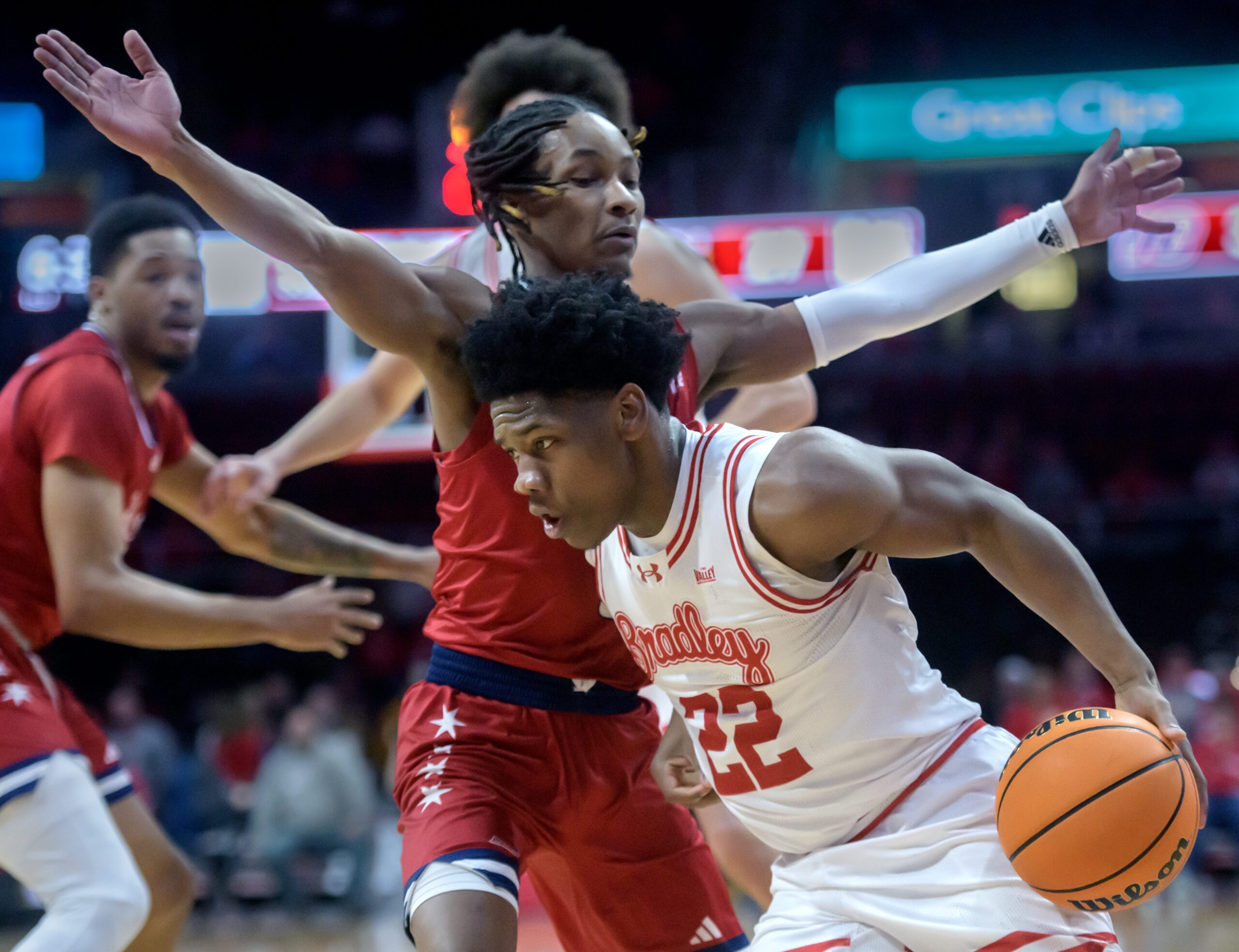 Bradley’s Jaquan Johnson (22) moves the ball against UIC’s Ahmad Henderson II in the first half of their MVC basketball game Wednesday, Jan. 29, 2025 at Carver Arena in Peoria. The Braves fell 93-70 to the Flames.