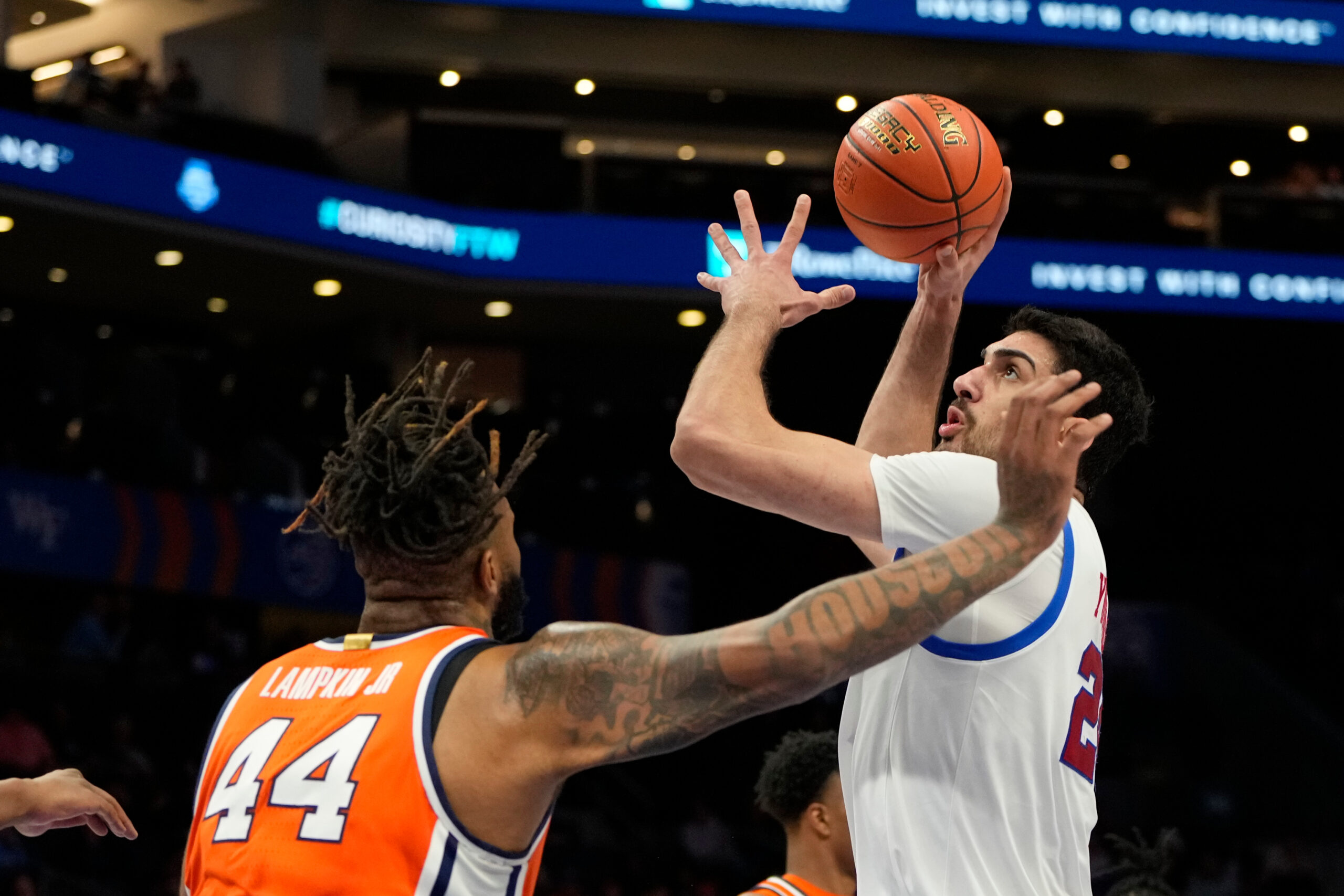 Mar 12, 2025; Charlotte, NC, USA; Southern Methodist Mustangs center Samet Yigitoglu (24) shoots as Syracuse Orange center Eddie Lampkin Jr. (44) defends in the first half at Spectrum Center. Mandatory Credit: Bob Donnan-Imagn Images