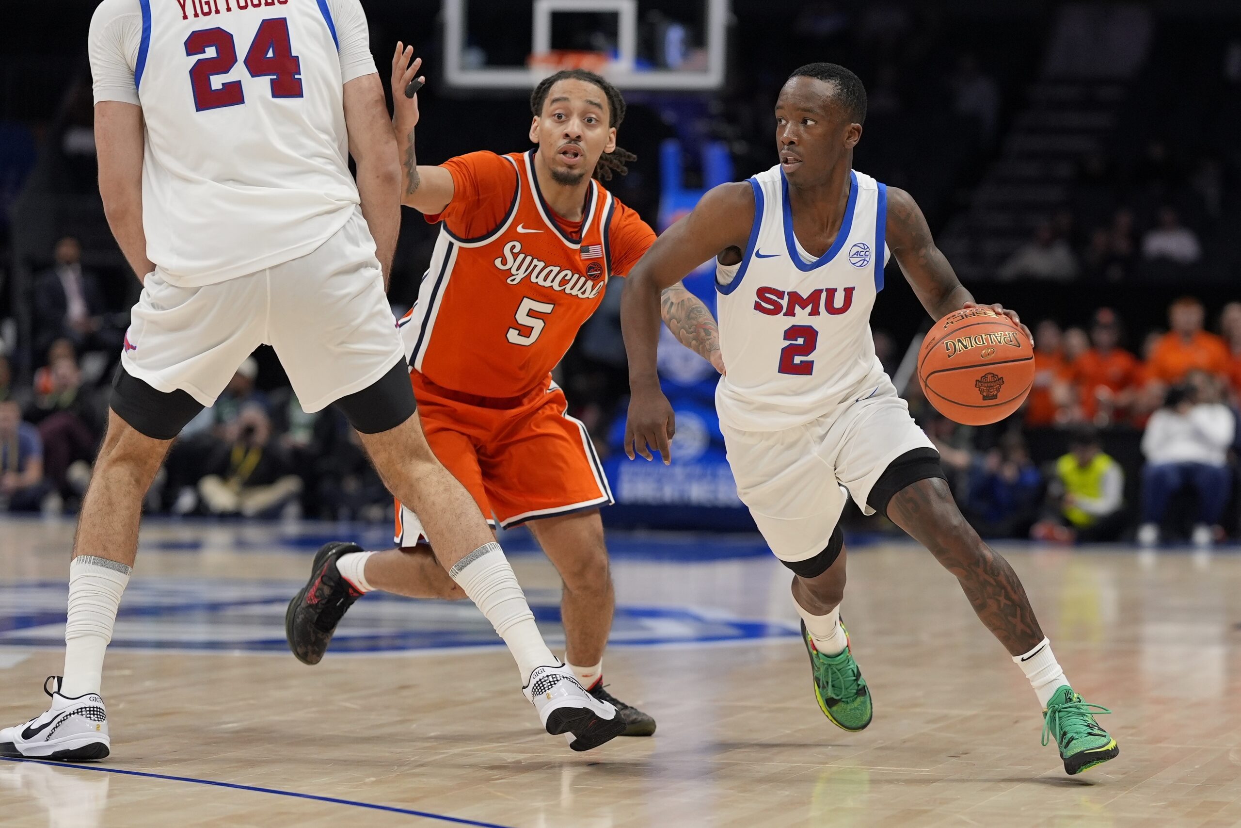 Mar 12, 2025; Charlotte, NC, USA;Southern Methodist Mustangs guard Boopie Miller (2) goes to the basket against Syracuse Orange guard Jaquan Carlos (5) during the second half at Spectrum Center. Mandatory Credit: Jim Dedmon-Imagn Images