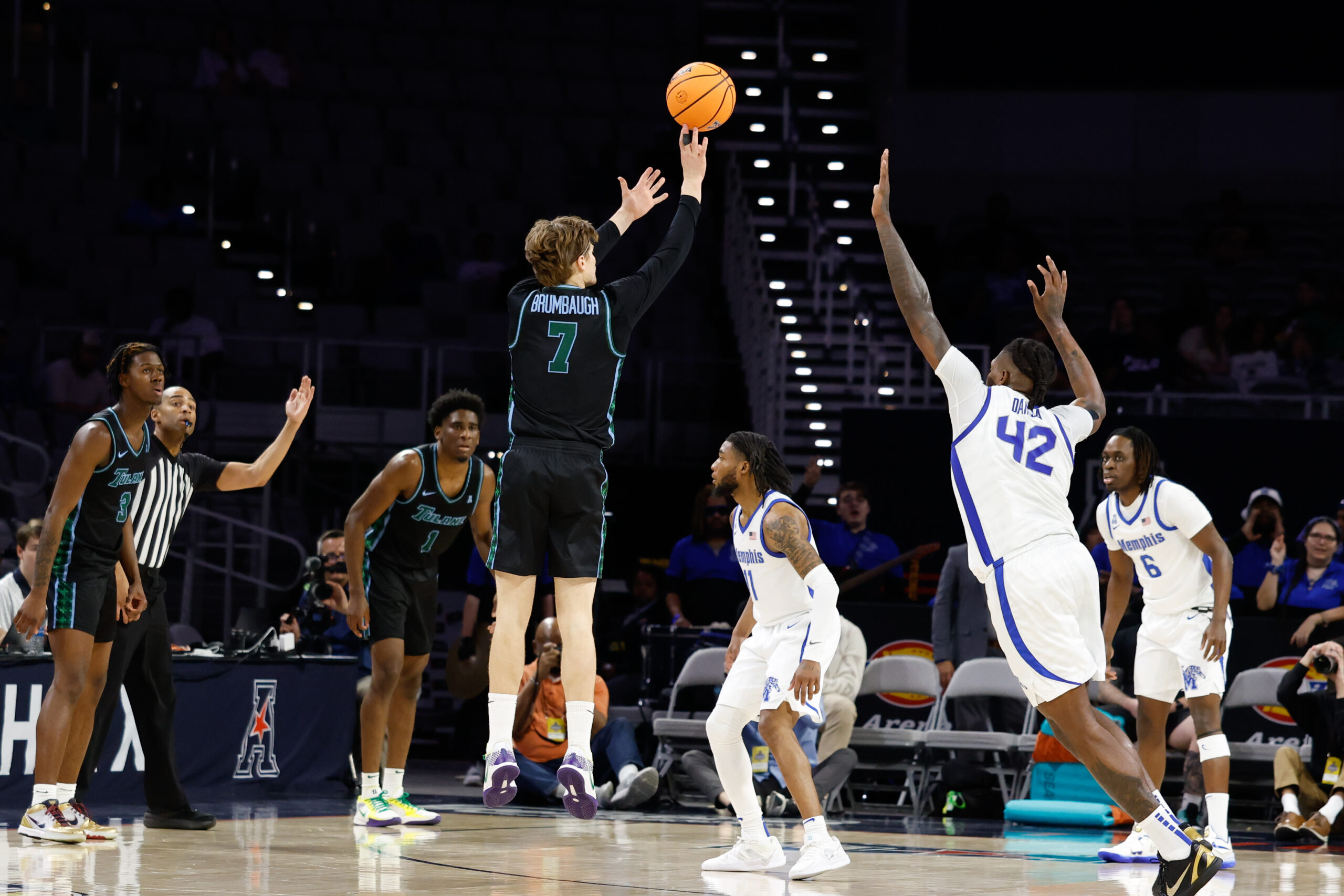 Mar 15, 2025; Fort Worth, TX, USA; Tulane Green Wave guard Rowan Brumbaugh (7) scores a three-point basket against Memphis Tigers forward Dain Dainja (42) during the first half at Dickies Arena. Mandatory Credit: Chris Jones-Imagn Images