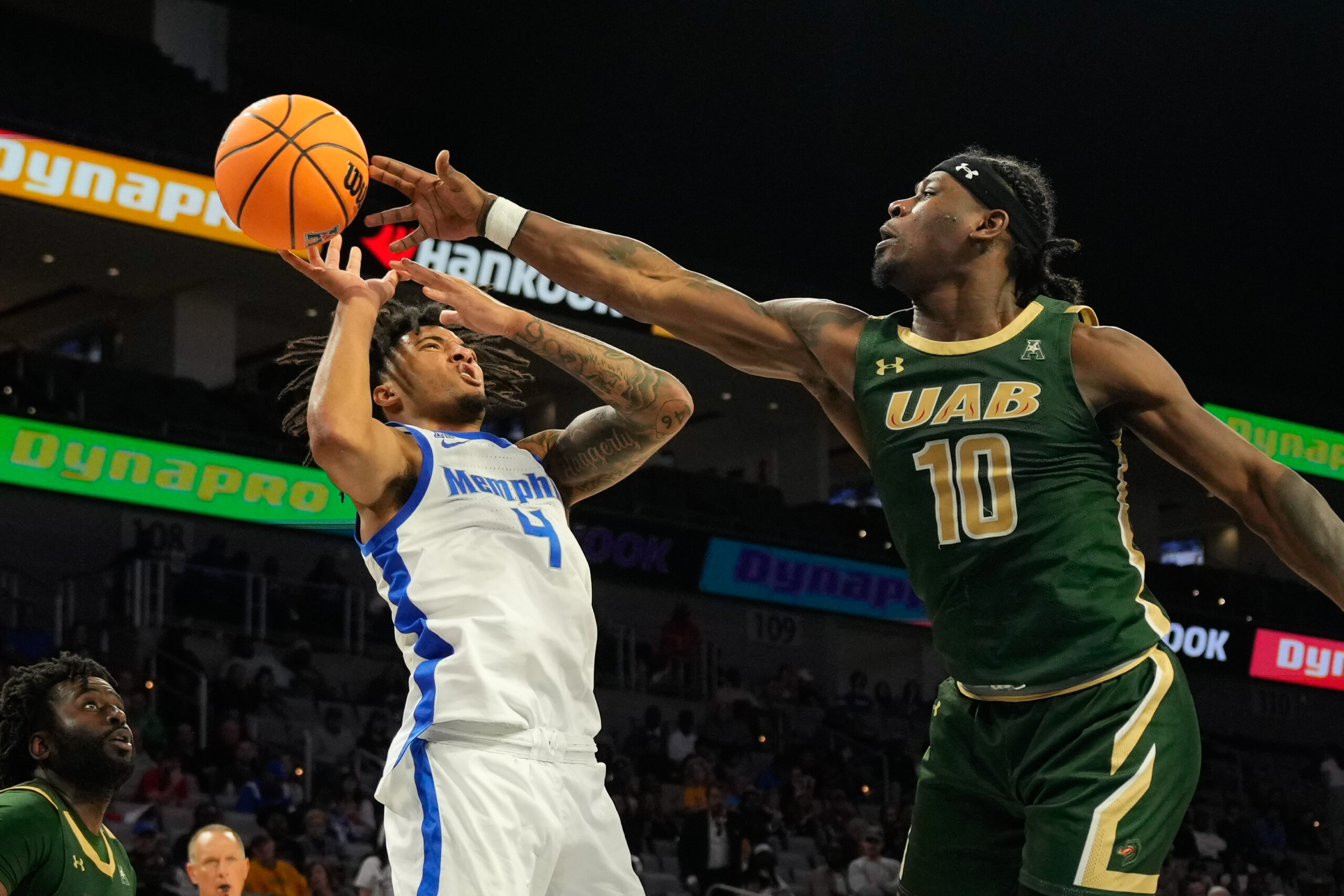 Mar 16, 2025; Fort Worth, TX, USA;  Memphis Tigers guard PJ Haggerty (4) has his shot bloked by UAB Blazers guard Alejandro Vasquez (10) during the second half at Dickies Arena. Mandatory Credit: Chris Jones-Imagn Images