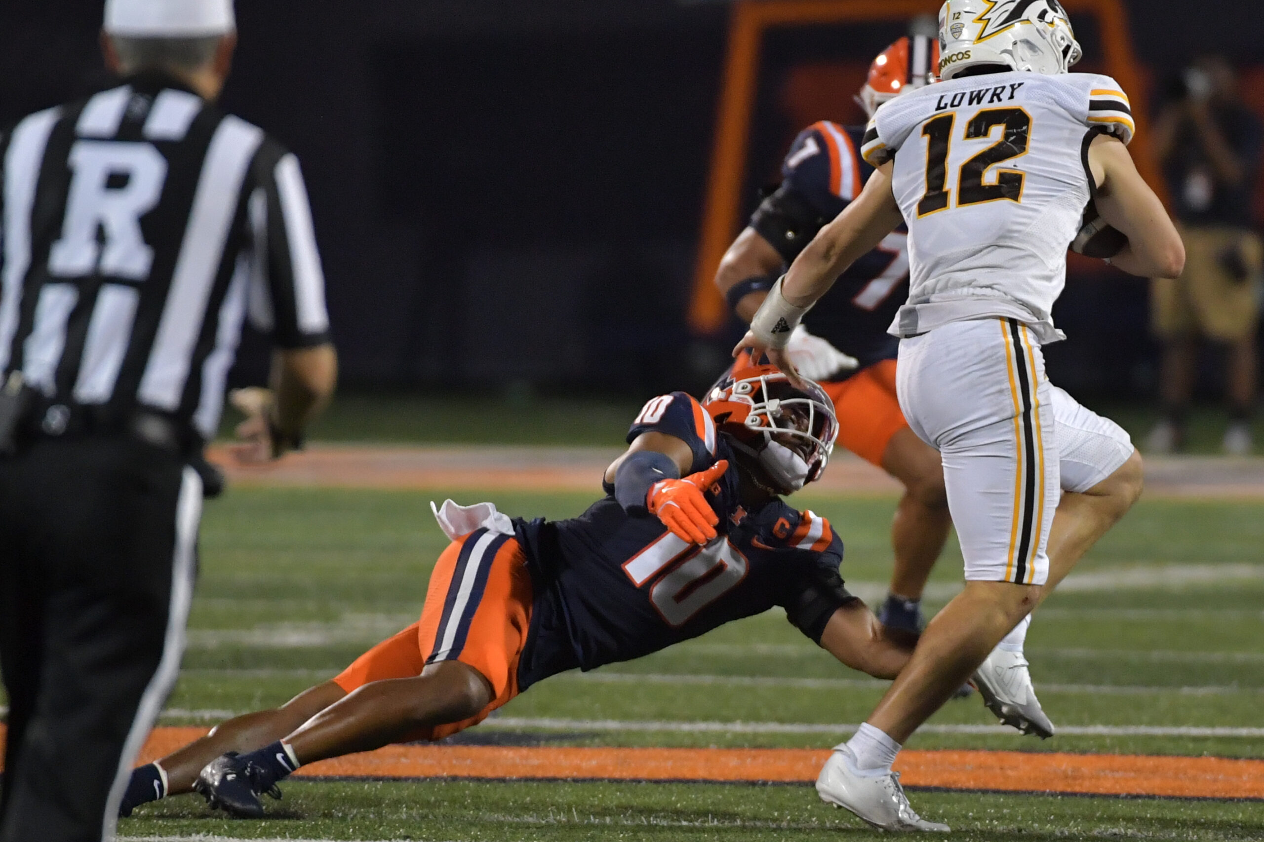 Sep 13, 2025; Champaign, Illinois, USA; Illinois Fighting Illini defensive back Miles Scott (10) tackles Western Michigan Broncos quarterback Broc Lowry (12) during the second half at Memorial Stadium. Mandatory Credit: Ron Johnson-Imagn Images