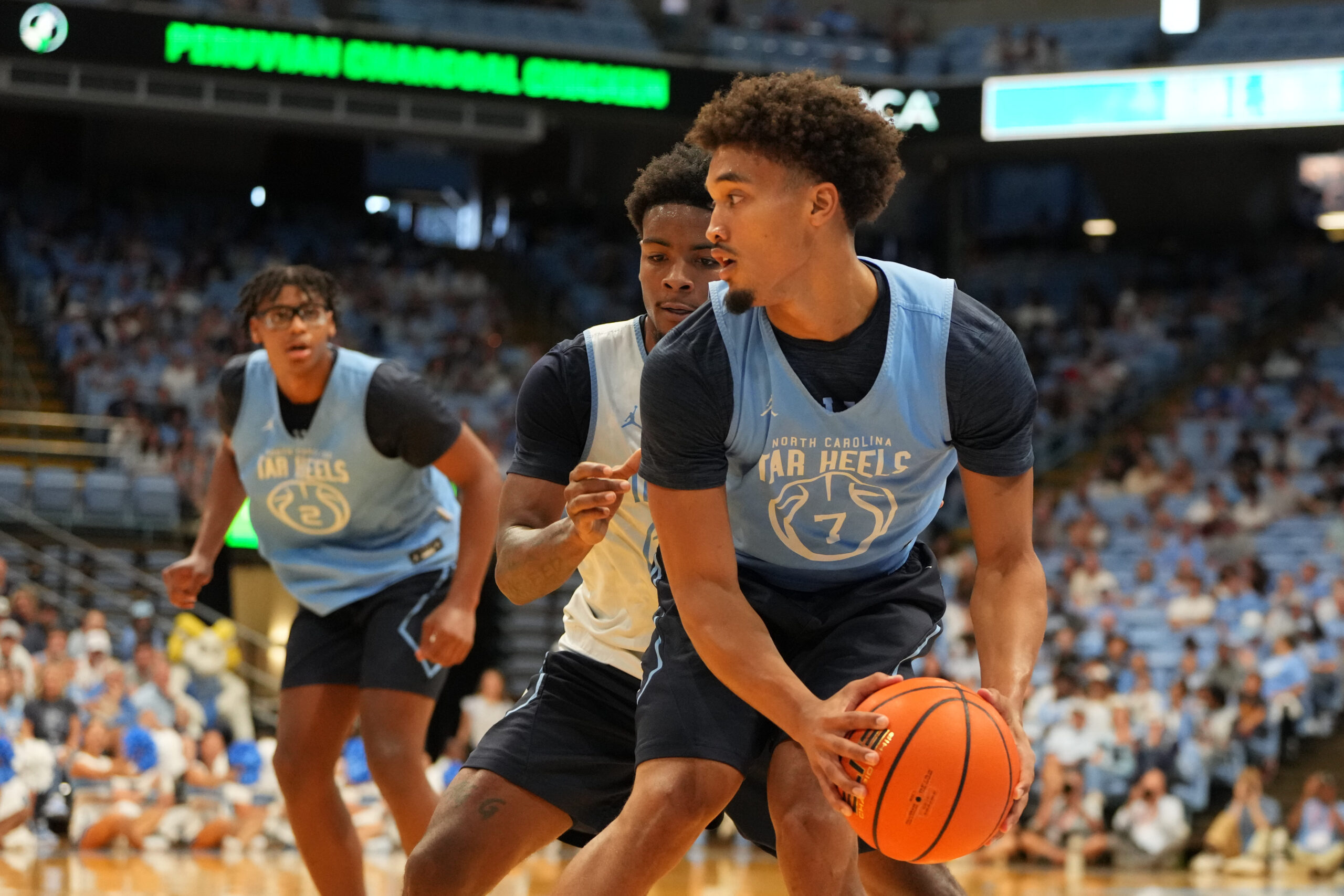 Oct 4, 2025; Charlotte, NC, USA; North Carolina Tar Heels guard Seth Trimble (7) with the ball as guard Jaydon Young (4) defends in the second half at Dean E. Smith Center. Mandatory Credit: Bob Donnan-Imagn Images
