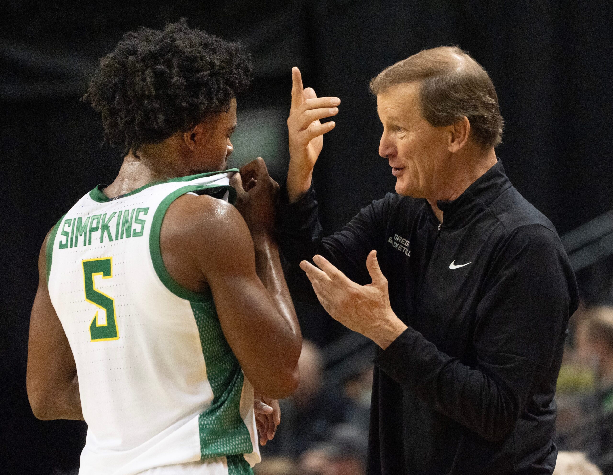 Oregon men's basketball coach, right, talks to Takai Simpkins during the exhibition game against Utah at Matthew Knight Arena Oct. 24, 2025.