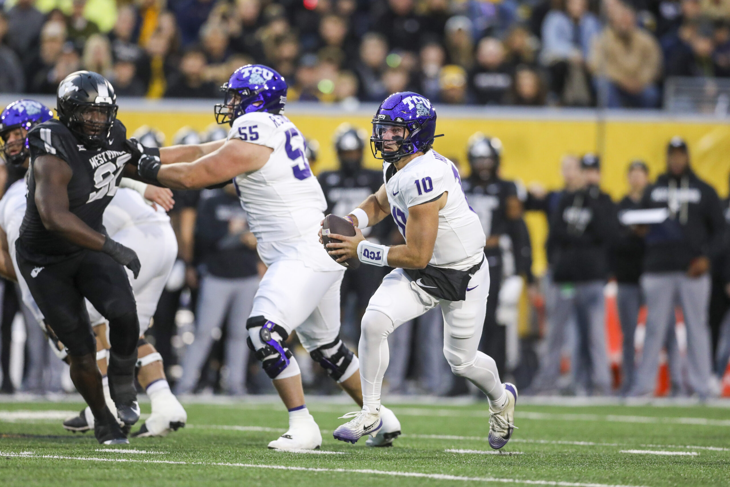 Oct 25, 2025; Morgantown, West Virginia, USA; Texas Christian University Horned Frogs quarterback Josh Hoover (10) runs out of the pocket during the first quarter against the West Virginia Mountaineers at Milan Puskar Stadium. Mandatory Credit: Ben Queen-Imagn Images