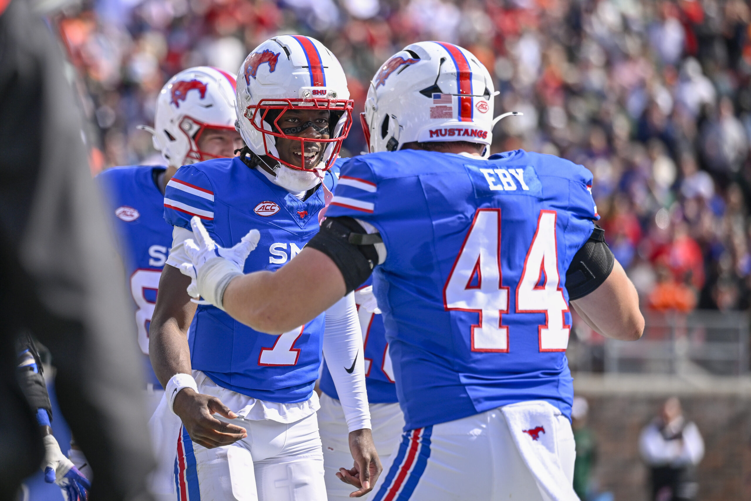 Nov 1, 2025; Dallas, Texas, USA;  SMU Mustangs quarterback Kevin Jennings (7) and tight end Stone Eby (44) celebrates after Jennings scores a touchdown against the Miami Hurricanes during the second half at Gerald J. Ford Stadium. Mandatory Credit: Jerome Miron-Imagn Images