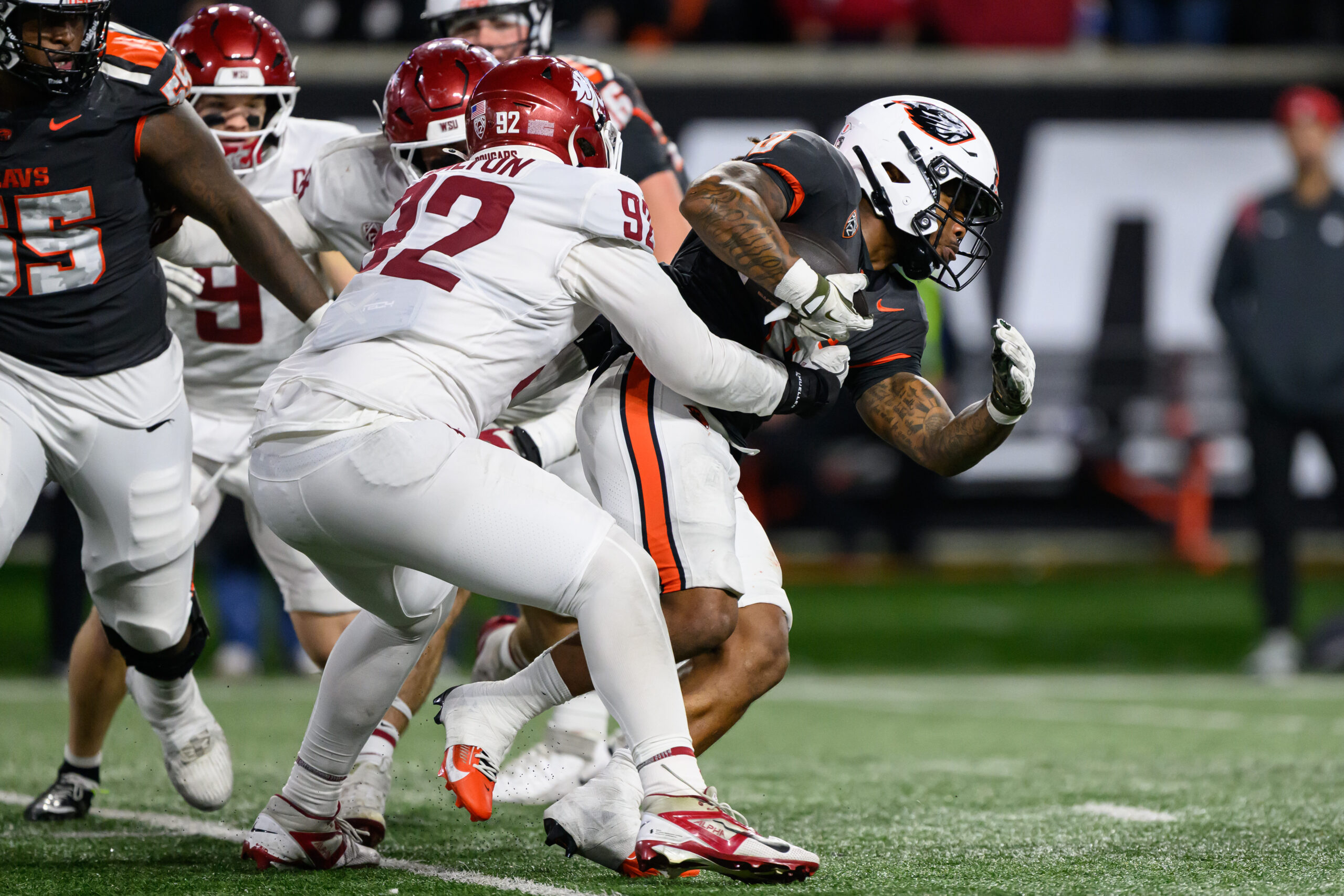 Nov 1, 2025; Corvallis, Oregon, USA; Washington State Cougars defensive lineman Darrion Dalton (92) tackles Oregon State Beavers running back Anthony Hankerson (0)  during the fourth quarter at Reser Stadium. Mandatory Credit: Craig Strobeck-Imagn Images