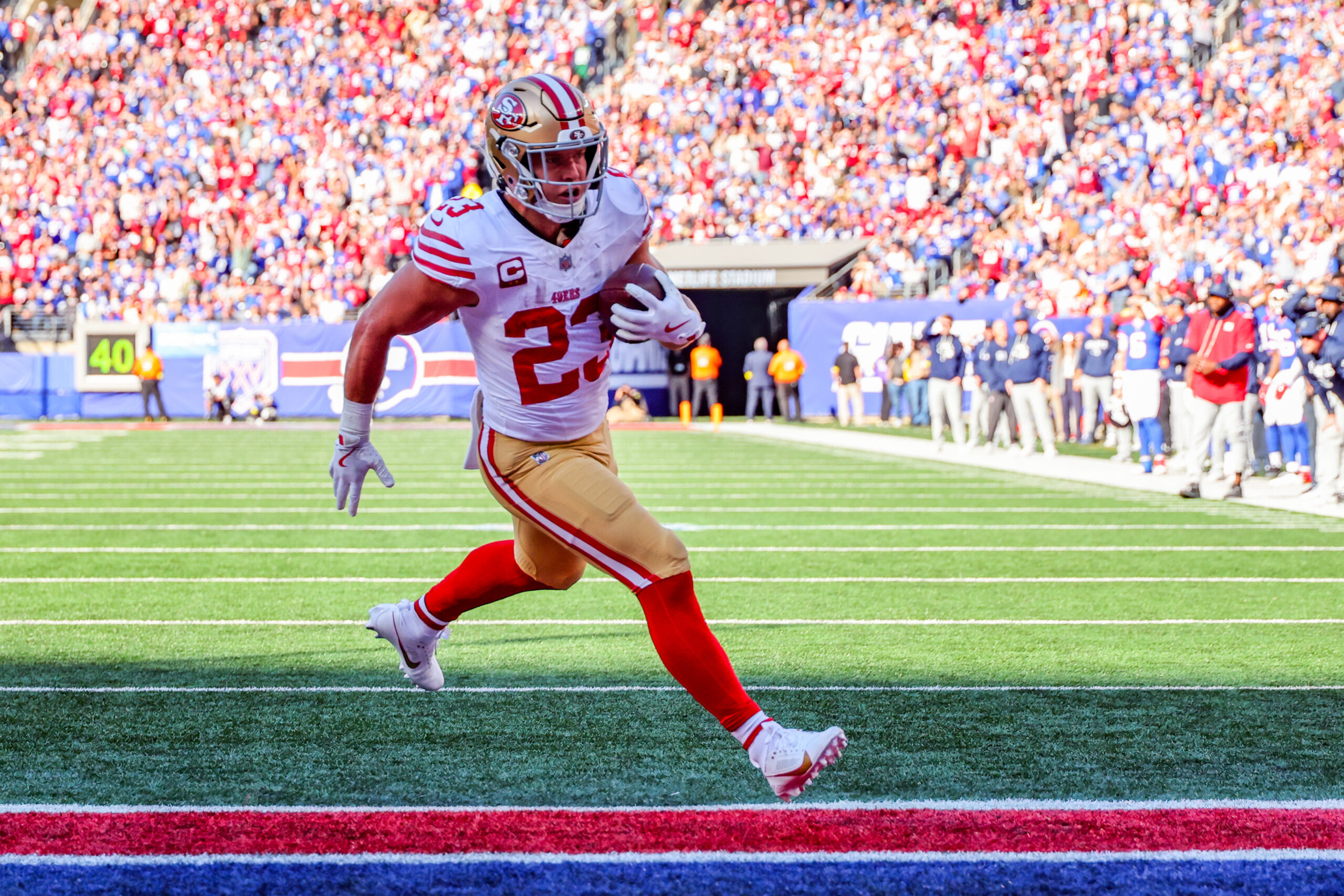 Nov 2, 2025; East Rutherford, New Jersey, USA; San Francisco 49ers running back Christian McCaffrey (23) runs after the catch for a touchdown against the New York Giants during the first half at MetLife Stadium. Mandatory Credit: Ed Mulholland-Imagn Images
