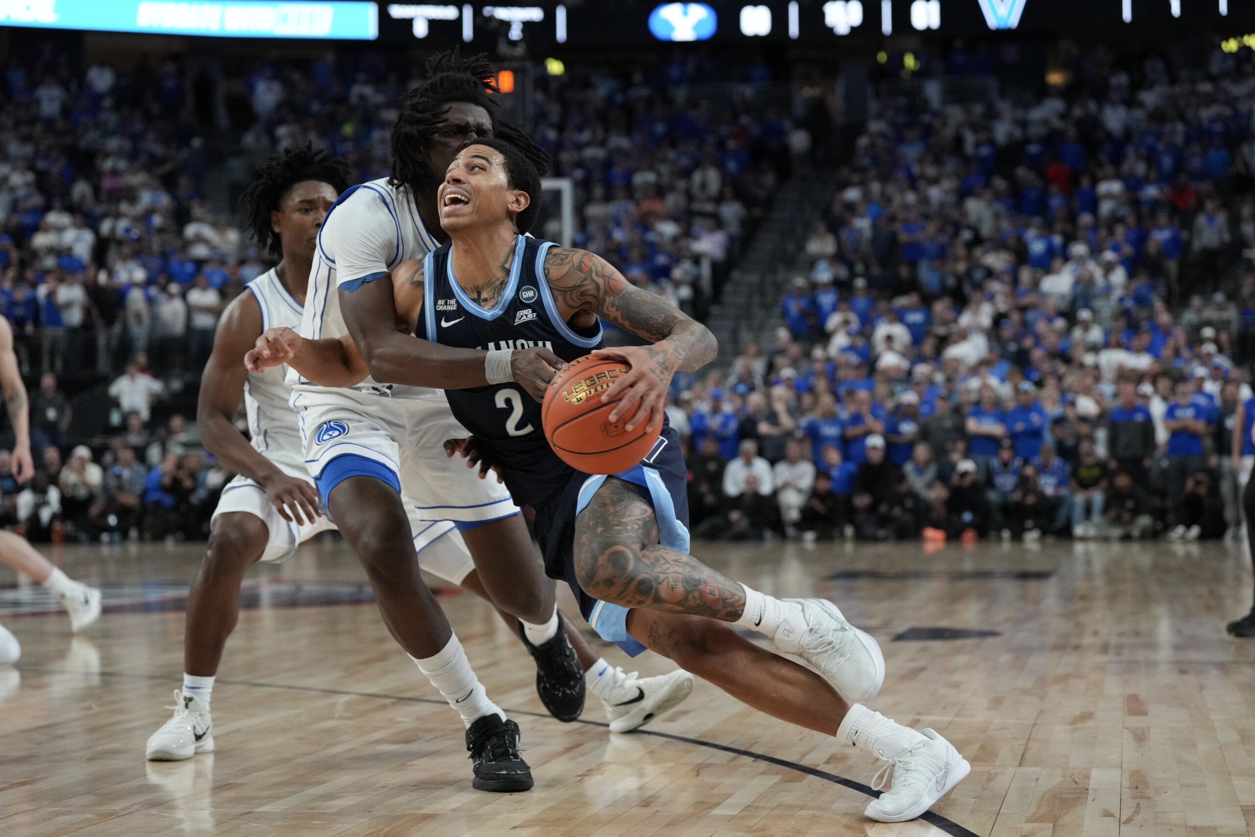 Nov 3, 2025; Las Vegas, Nevada, USA; Villanova Wildcats guard Bryce Lindsay (2) is fouled by BYU Cougars forward Khadim Mboup (7) during the second half of the Hall of Fame Series game at T-Mobile Arena. Mandatory Credit: Candice Ward-Imagn Images