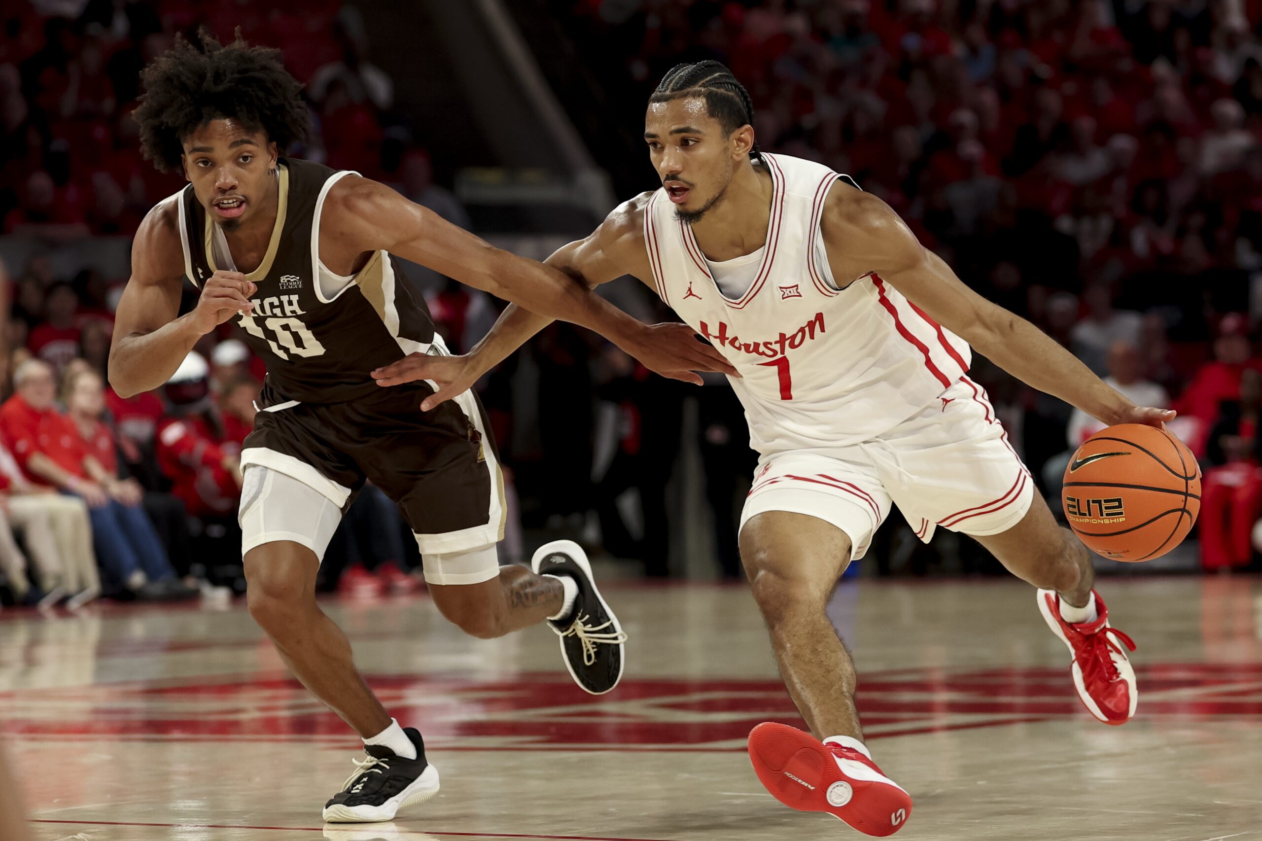 Nov 3, 2025; Houston, Texas, USA; Houston Cougars guard Milos Uzan (7) drives against Lehigh Mountain Hawks guard Caleb Thomas (10) during the first half at Fertitta Center. Mandatory Credit: Maria Lysaker-Imagn Images