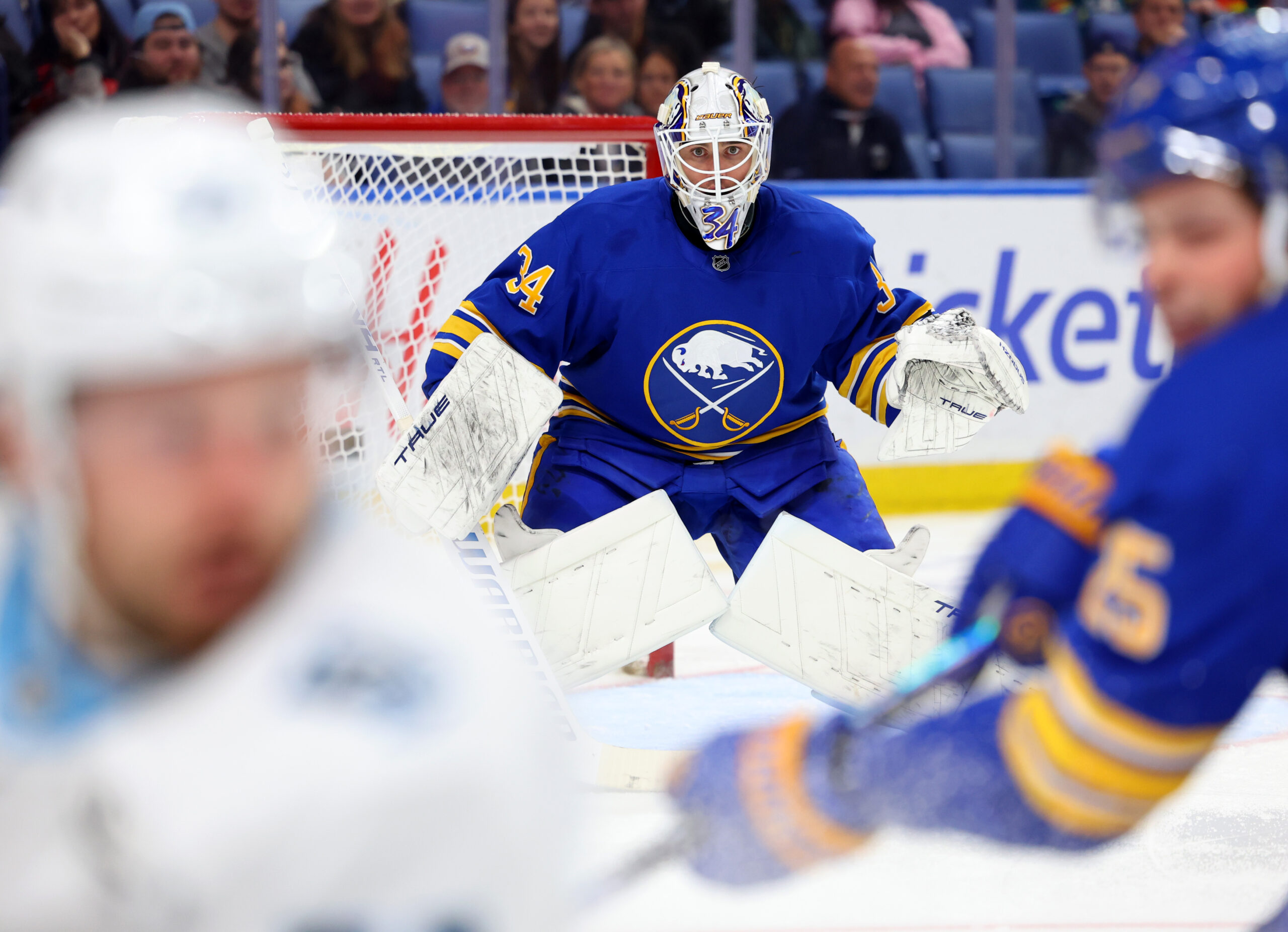Nov 4, 2025; Buffalo, New York, USA;  Buffalo Sabres goaltender Alex Lyon (34) looks for the puck during the third period against the Utah Mammoth at KeyBank Center. Mandatory Credit: Timothy T. Ludwig-Imagn Images