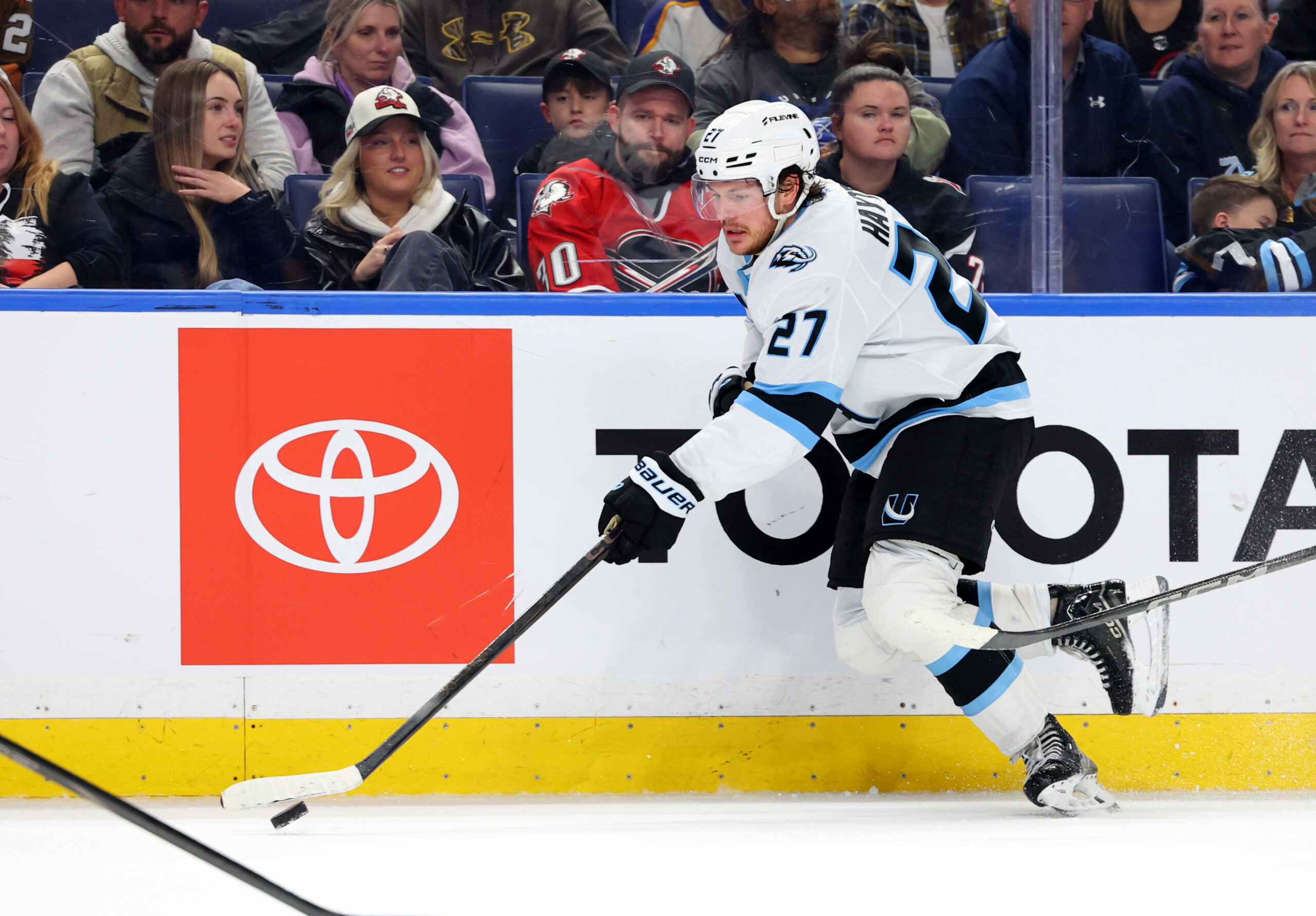 Nov 4, 2025; Buffalo, New York, USA;  Utah Mammoth center Barrett Hayton (27) skates up ice with the puck during the third period against the Buffalo Sabres at KeyBank Center. Mandatory Credit: Timothy T. Ludwig-Imagn Images