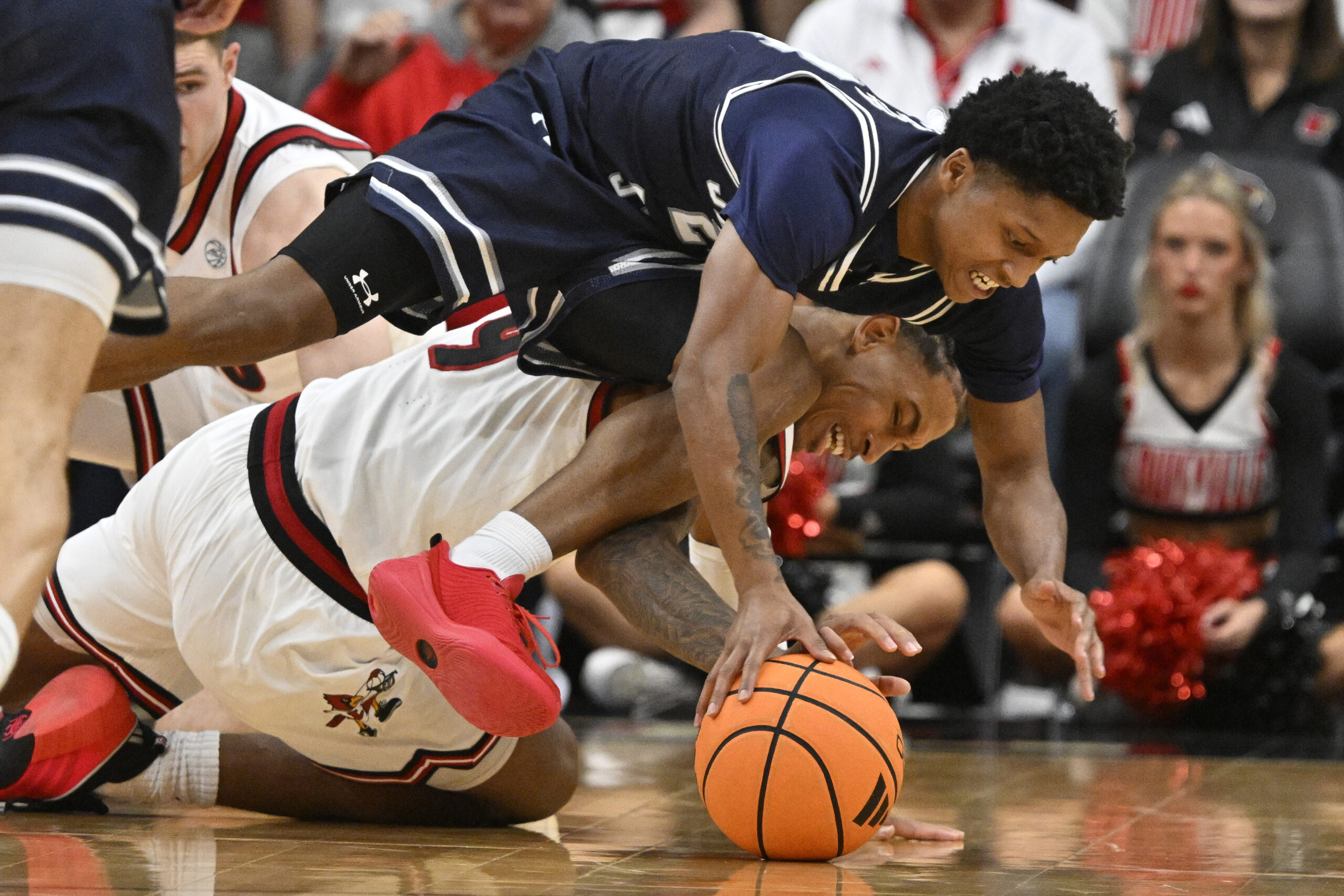 Nov 6, 2025; Louisville, Kentucky, USA;  Jackson State Tigers guard Daeshun Ruffin (24) scrambles for the ball with Louisville Cardinals forward Khani Rooths (9) during the second half at KFC Yum! Center. Louisville defeated Jackson State 106-70. Mandatory Credit: Jamie Rhodes-Imagn Images