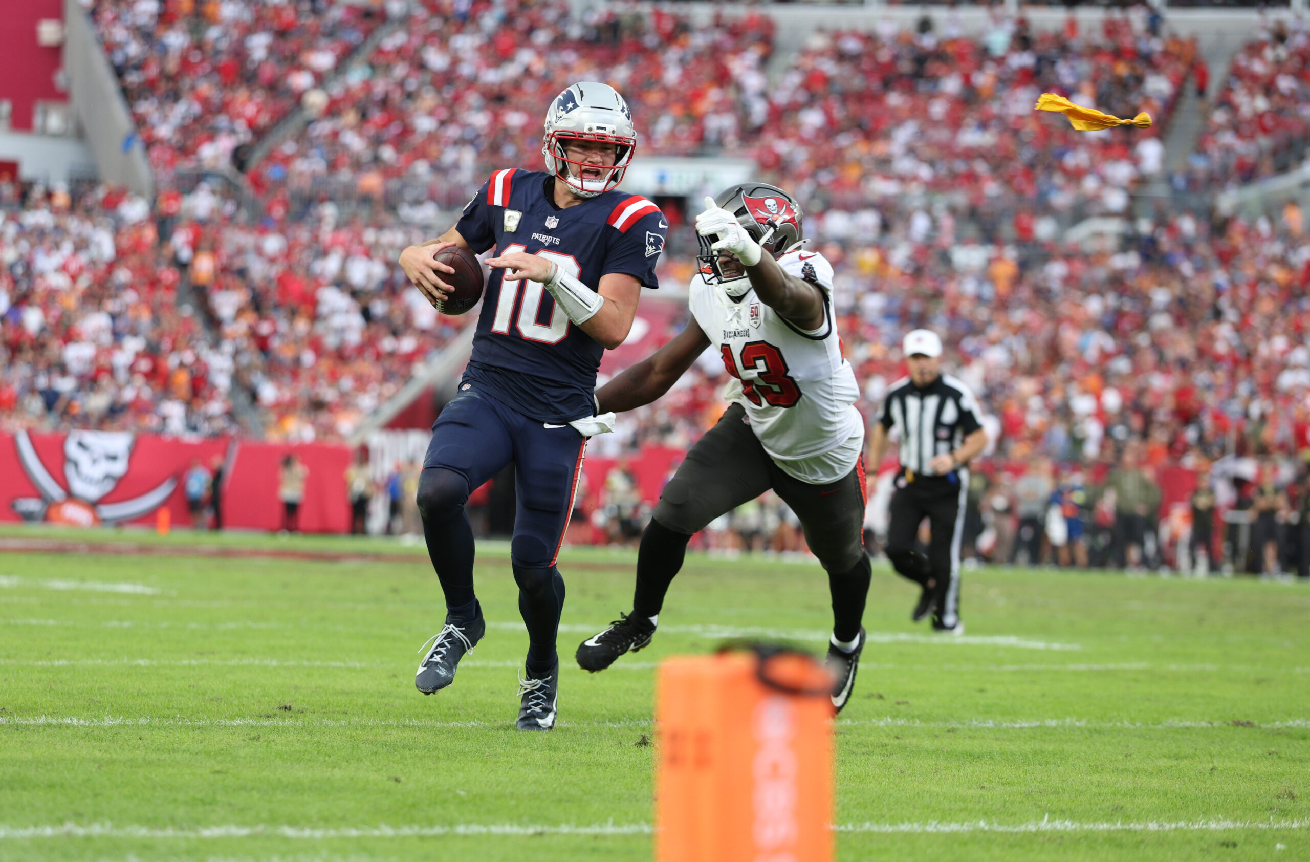 Nov 9, 2025; Tampa, Florida, USA; New England Patriots quarterback Drake Maye (10) runs for a gain past Tampa Bay Buccaneers safety Tykee Smith (23) during the fourth quarter at Raymond James Stadium. Mandatory Credit: Nathan Ray Seebeck-Imagn Images
