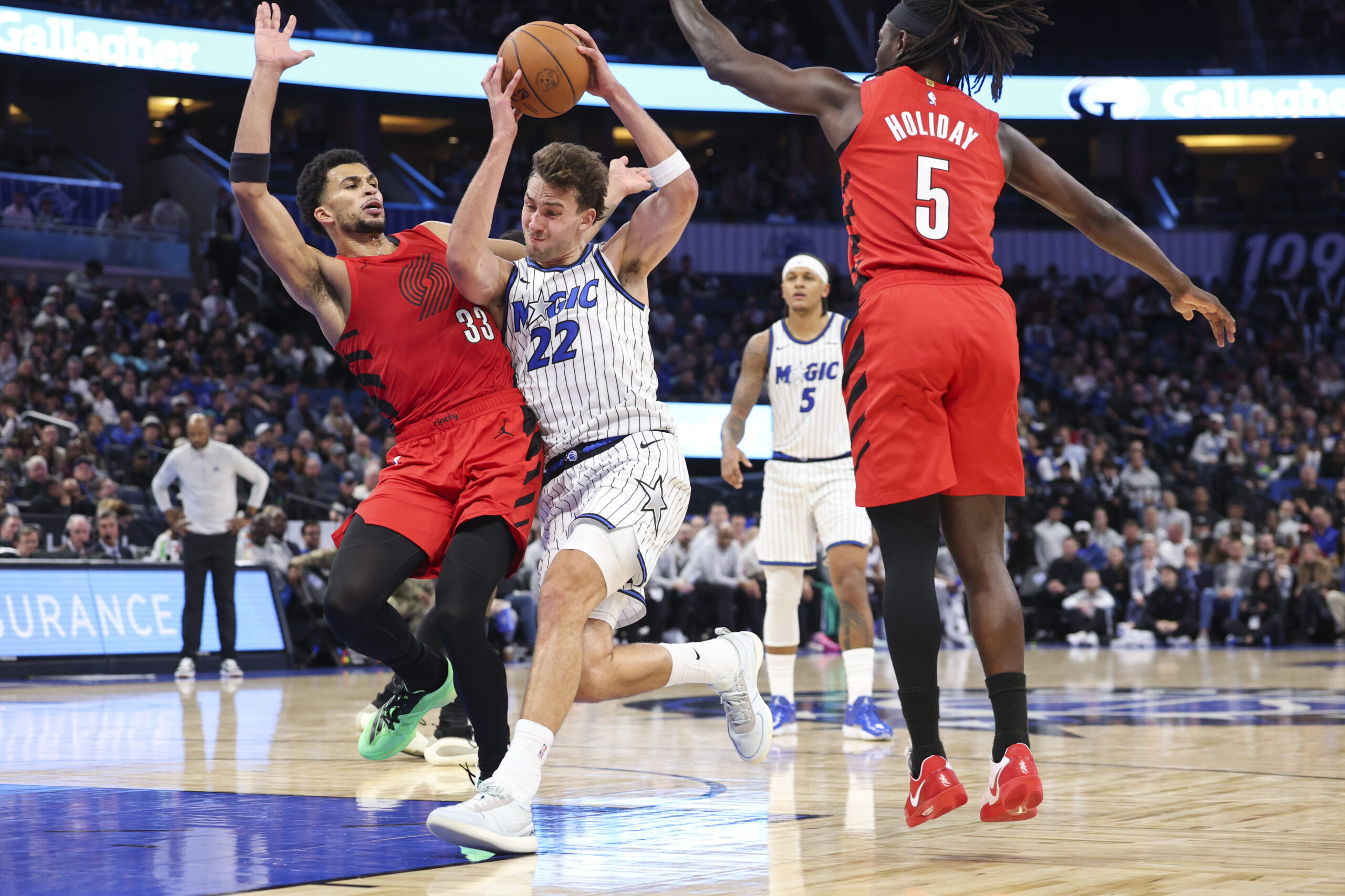 Nov 10, 2025; Orlando, Florida, USA; Orlando Magic forward Franz Wagner (22) drives to the basket past Portland Trail Blazers forward Toumani Camara (33) in the fourth quarter at Kia Center. Mandatory Credit: Nathan Ray Seebeck-Imagn Images