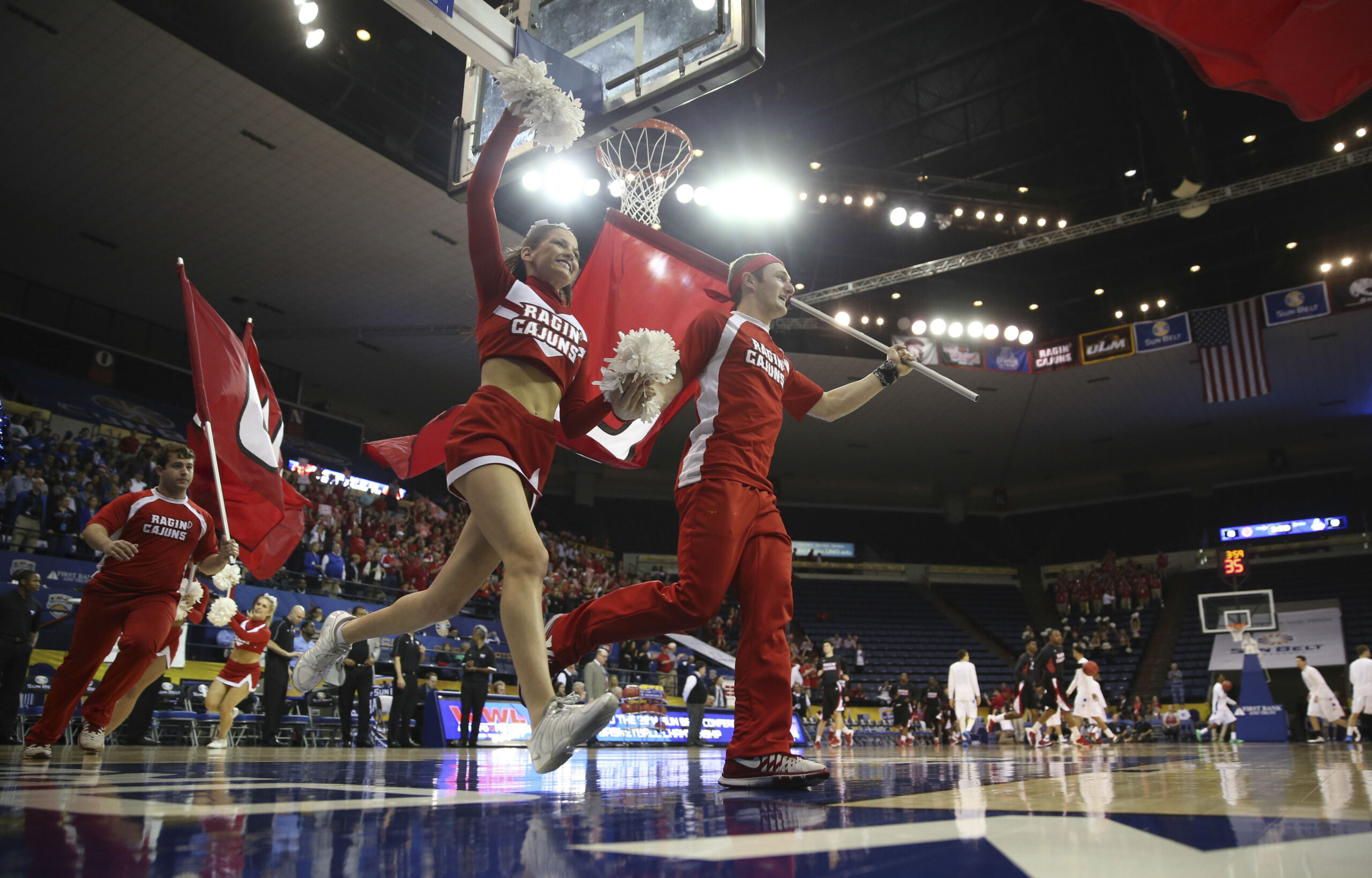 Mar 16, 2014; New Orleans, LA, USA; Louisiana Lafayette Ragin Cajuns cheerleaders lead the team onto the court prior to tipoff against the Georgia State Panthers in the championship game of the Sun Belt Conference college basketball tournament at Lakefront Arena. Louisiana Lafayette defeated Georgia State 82-81. Mandatory Credit: Crystal LoGiudice-Imagn Images